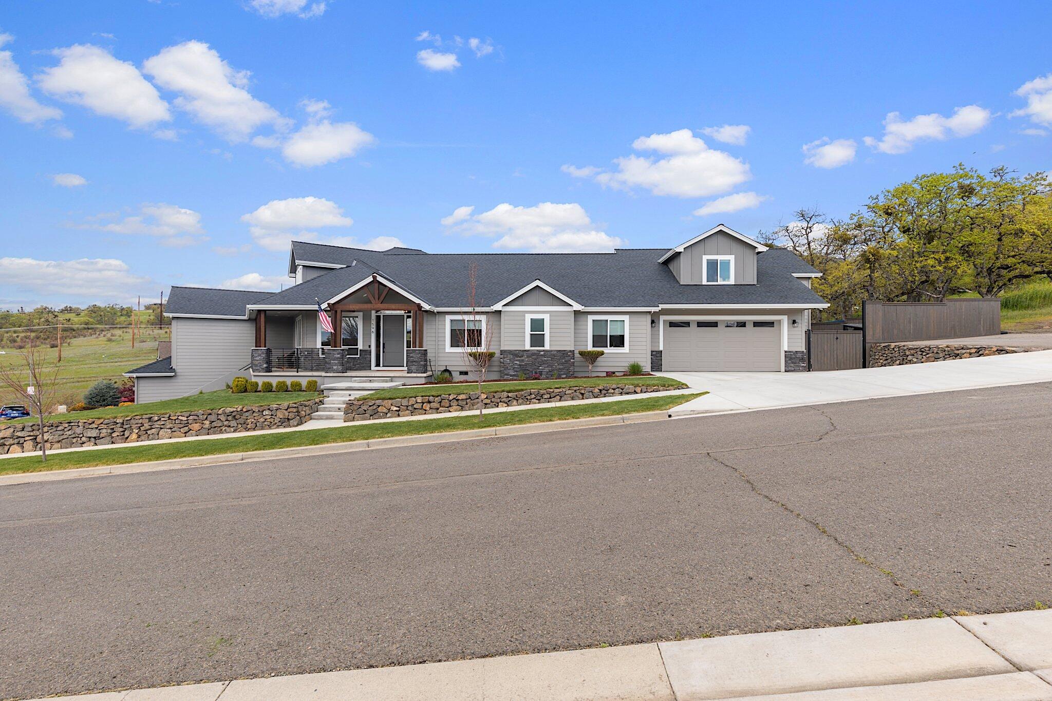This stunning custom home situated in the desirable East Medford Hills boasts 3844 Sq/Ft with 5 bedrooms and 3.5 baths.  Built in 2020, the thoughtful design showcases incredible valley views and unforgettable evening sunsets. Situated on a corner lot with generous parking, an oversized 2 car main garage and additional 16'x38' garage on lower level. The use of structural steel allows large spans to maximize the spacious layout with 11' ceilings featuring a 23' hickory tongue and groove vault. The kitchen boasts an oversized island with Quartzite slab, Jenn-Air appliances, abundant cabinets, pantry and granite countertops. The main level split floor plan includes 3 bedrooms and a master bedroom with generous ensuite and walk-in closet. Upstairs includes a bedroom, full bathroom and living room. Additional features include two dual fuel HVAC systems, hardwood floors, custom tile work, and a private backyard with gas firepit. With incredible attention to detail, this is a must see!