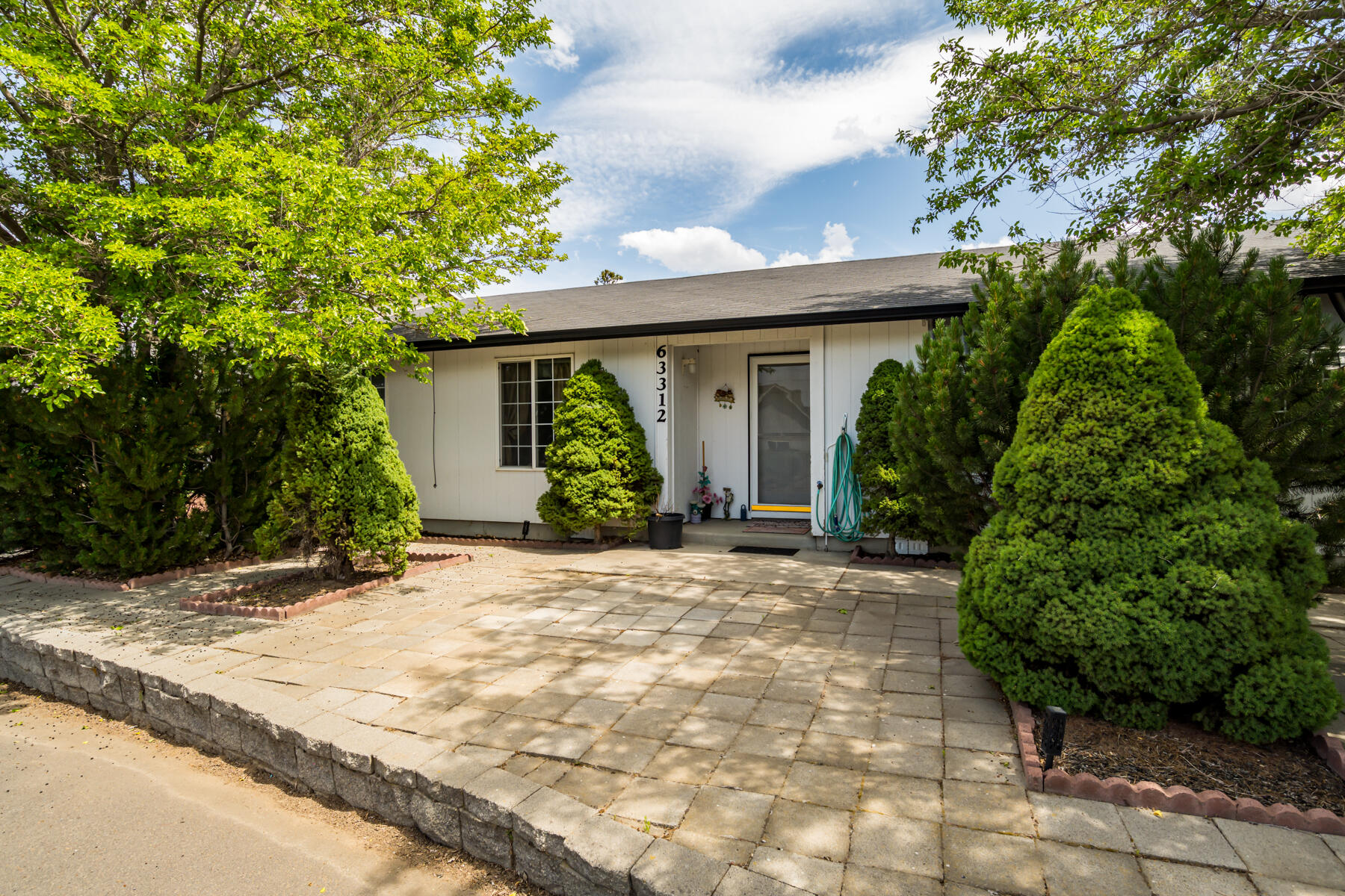 Welcome to this well-maintained single-level home offering 1,704 square feet of comfortable living space on a quiet street. The open floor plan features a light-filled kitchen with a cozy nook and additional dining area .A welcoming living room just off the entry. The spacious primary suite provides a large walk in closet, complemented by two additional bedrooms and a full guest bath—ideal for family, guests, or a home office setup.
Step outside to enjoy the low-maintenance backyard, complete with a tranquil water feature, relaxing hot tub, and a storage shed for added convenience. The extra-large side yard offers ample space for additional parking, toys, or garden beds. The fully insulated two-car attached garage ensures year-round functionality.
Backs to a peaceful common area for added privacy—bring your creative touches and make this home your own!
