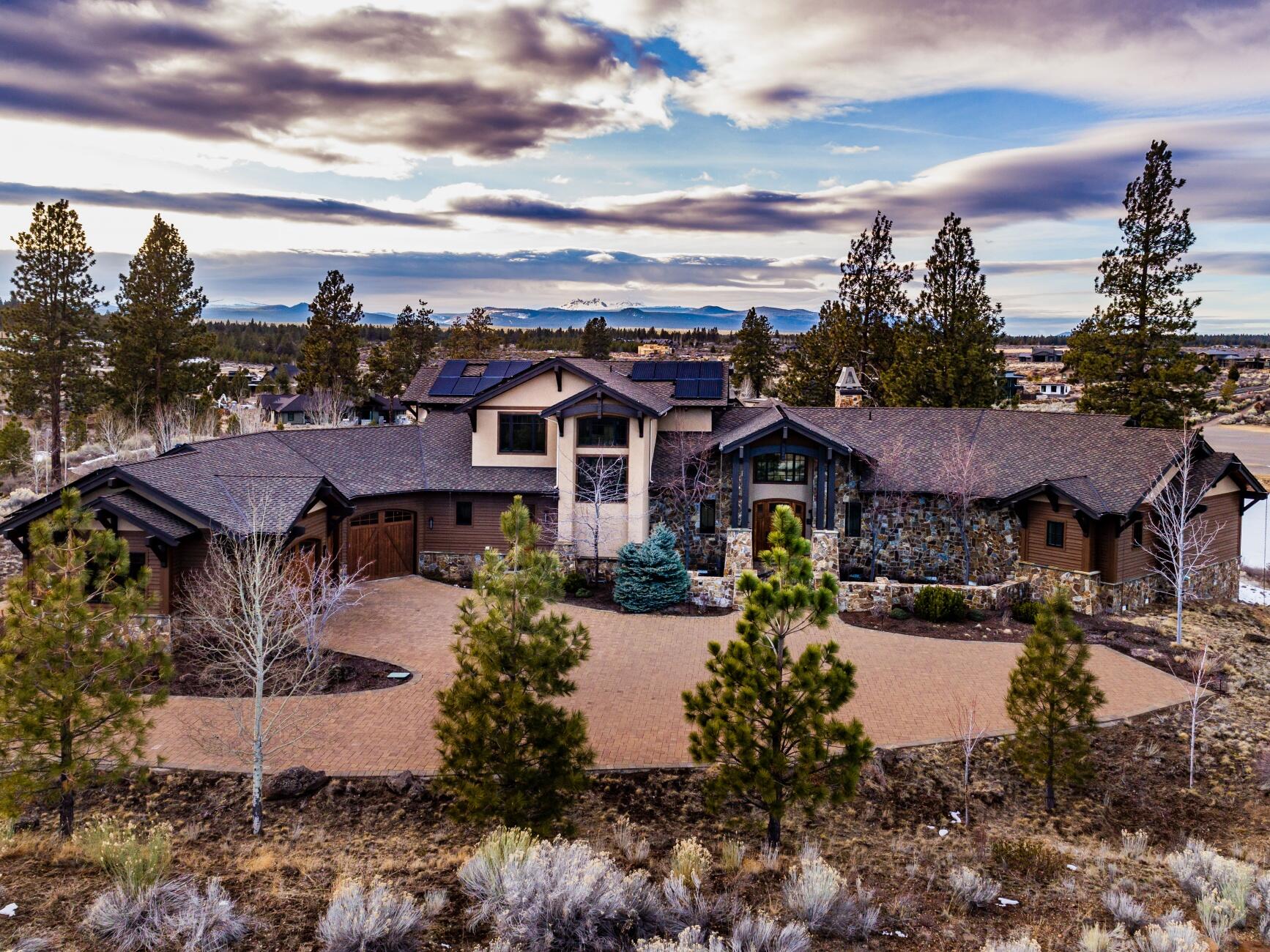 Stunning NW Artisan Home perched on one of Tetherow's Premier Lots, affording one of the best settings in Central Oregon. This Custom 4,727 Square Foot Property takes advantage of natural vistas and views. The Cascade Mountains stretch along the West side of the property, and a one-of-a-kind view down the 15th and 13th fairways, overlooking one of Tetherow's two golf course ponds. No detail was overlooked in this Estate. Featuring a true Chef's Kitchen with a Large Island, and an open concept floor plan that seamlessly connects the
Great Room, Dining Room, Bar and Kitchen together. The Master Wing is located on the Main Level of the property, featuring a Grand Master Bedroom, Spacious Walk In Closet, and a Stunning Master Bath Suite.
Additionally, the Large Office/Study is located adjacent to the Master Suite, all offering Cascade and Golf Course Views.