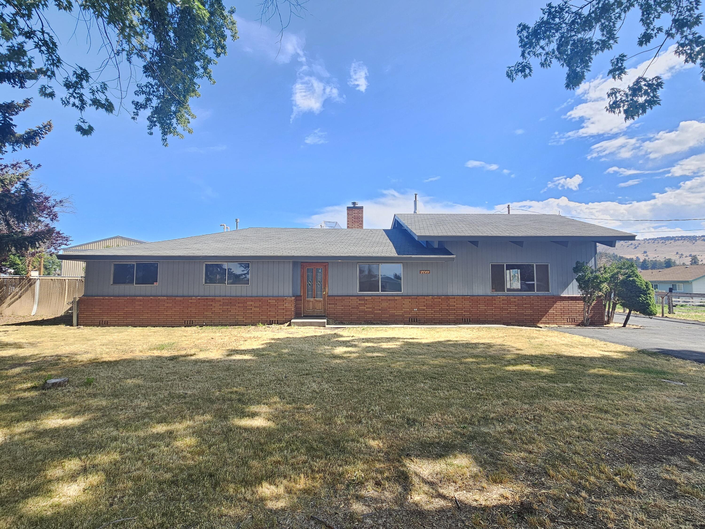 Country atmosphere with 1.6 acres just outside of town! Spacious ranch-style design. The additional features like a paved parking area, two-car garage, and separate workrooms offer great convenience. The barn and cross-fenced property provide opportunities for gardening or keeping animals, while being close to town adds the benefit of accessibility to amenities. It is a perfect blend of country living with urban convenience!