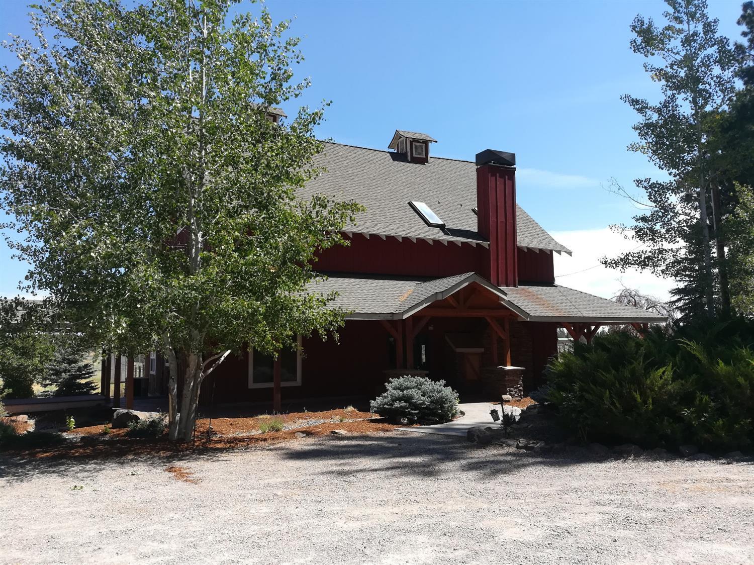 Unique 1900's barn converted to home w/Tennis court, 4 stall barn, riding arena/pasture. Open floorplan, large windows, fireplace & wood floors. Kitchen has isle w/granite counter-tops & huge pantry & Skylights. large master on main suite has walk-in closet & jet tub. 2nd floor has great room plus 2BD/1BA. Star gazing bed & bath on 3rd floor. Attached(by breezeway) 3-car garage & 2BD+1BA story guest/hobby space. Fenced pastures w/6 acres of ground water rights:buyer to verify well & building permits