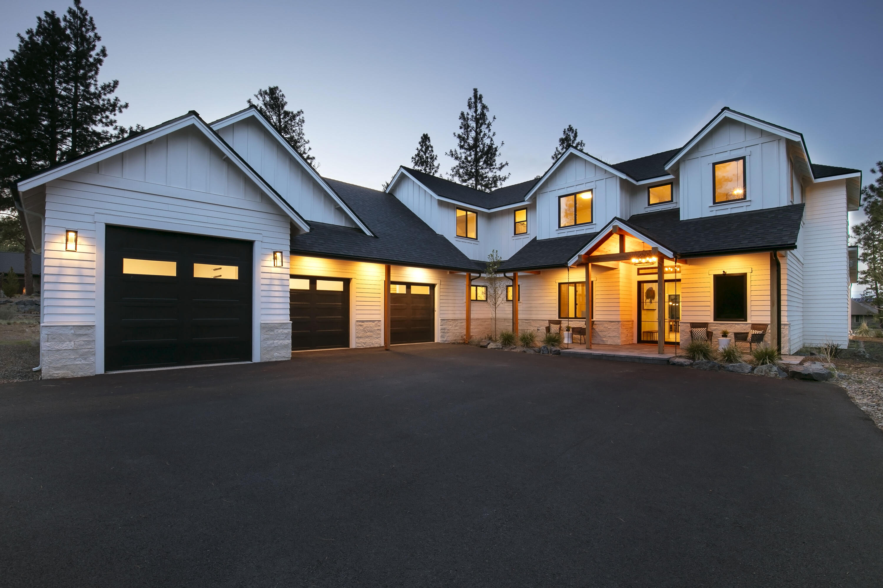 A perfect balance of luxury and nature in this custom retreat on 2.5 tranquil acres just outside Bend. Designed with exceptional detail, the open-concept floor plan features a great room with propane fireplace and a chef's kitchen with oversized island, double ovens, wine bar, built-in refrigerator, and butler's pantry. The main level offers a spacious primary suite with private patio and a versatile den, while the upper level includes three bedrooms and a bonus room. Outdoor living is enhanced with a covered paver patio and fire pit, ideal for year-round enjoyment. The expansive lot provides space for a shop or ADU. A three-car garage includes a workshop, vaulted middle bay, and 10' door on the third bay. Modern finishes throughout complete this exceptional property.