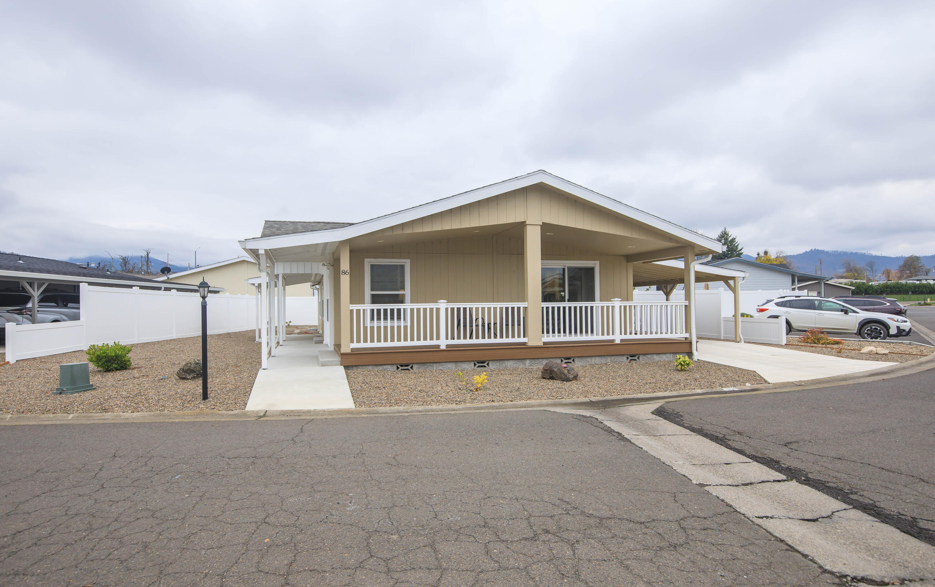 Built in 2022, this Marlette home shines with modern comfort & thoughtful design. Offering 1,344 sq ft, the floor plan lives large, thanks in part to a versatile den with French doors that's perfect for work, hobbies, or cozy movie nights. The kitchen is open & inviting, featuring a pantry & stainless-steel appliances. Generous windows & an eye-catching architectural ceiling add a stylish lift to the living room. The dining area flows seamlessly onto the showstopper front porch through sliding doors, ideal for morning coffee, evening relaxation, or effortless indoor-outdoor entertaining. The primary suite includes a faux-tile step-in shower, double sinks, & linen storage for convenience. With low-maintenance landscaping, a storage shed tucked under the carport, & guest parking right next door, the home is designed for easy living. Just steps from the park office & the community pool, this bright, sunny home brings together comfort, convenience, & contemporary charm. It's a standout!