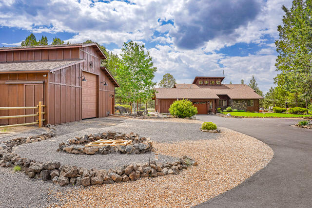 Amazing one level ranch style home on 2.45 beautiful acres. The living room, kitchen and dining area are open and inviting. The Great room opens to the back deck with amazing views of The Three Sisters, other Mountain ranges, and beautiful Sunsets! . Soaring stone fireplace connects to vaulted ceilings boasting tongue and groove cedar. Hard wood and Slate tile floors throughout the home. French doors leading to the back deck in the Primary bedroom allows tons of sunshine in. Attached over sized 2 car garage offers spacious storage. New 36'X36' Barn/shop offers stunning views of the mountains. With 3- 12' x 12' stalls, a tack room, ideal for gear/ weight room/storage, built in 2022 contains office/bedroom with a full bathroom. Ideal for a home business, visitors or in-laws.  Property shown by appointment only,