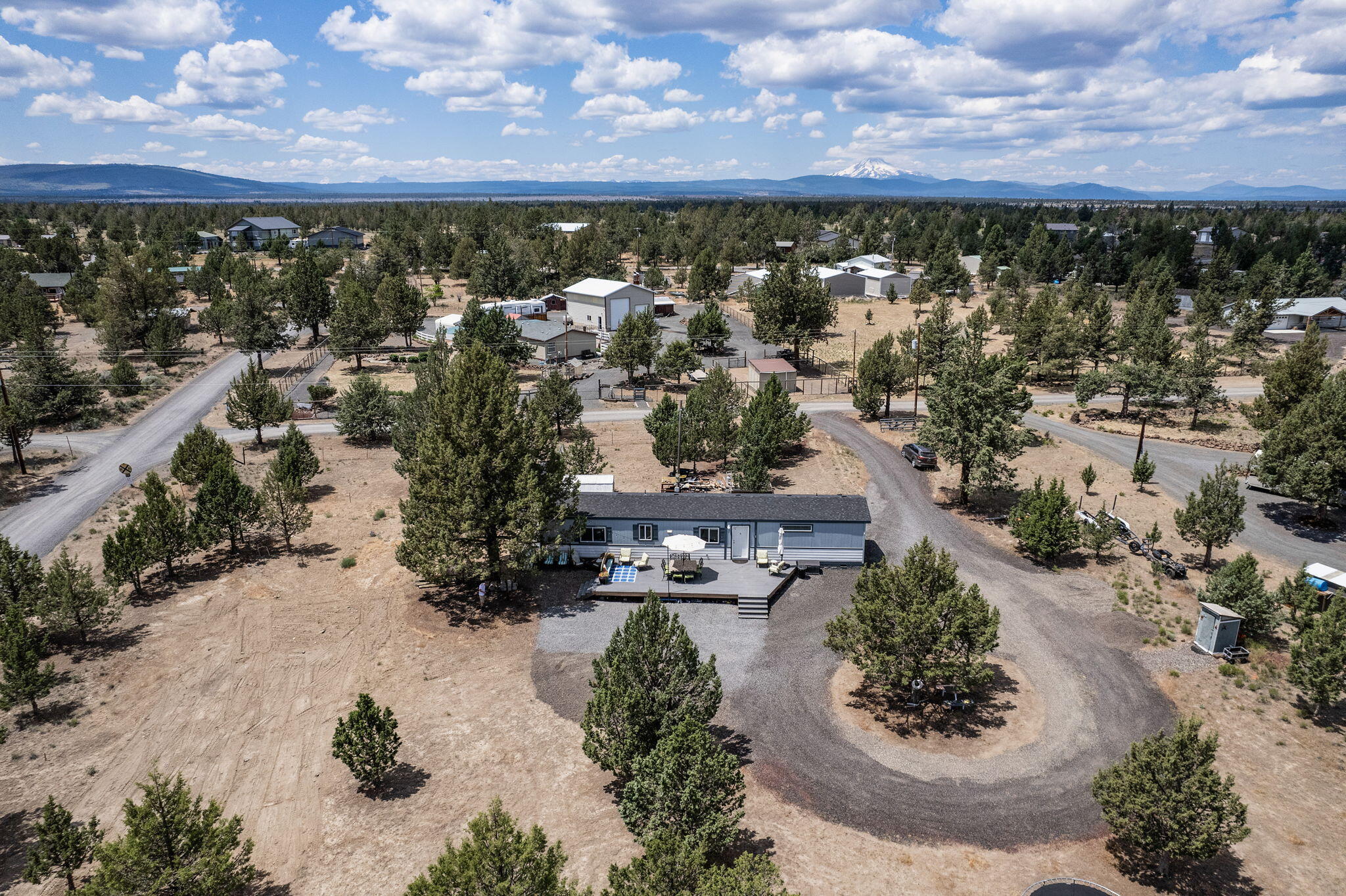 Your perfect weekend and summertime getaway! This property is located just 10 minutes from the Deschutes River Boat Launch at the Cove Palisades State Park and Lake Billy Chinook. Relax to sip coffee in the morning and wine in the evening on an expansive, zero maintenance Trex deck. Open floor plan with upgrades including roof insulation R-38, SS appliances and farmhouse sink, crown molding, and A/C is wired and ready for a unit to be placed if desired by the buyer. Freshly manicured lot with new gravel for easy pull through access for boats/RV.  RV hook ups. Shed for storage and new pump house and pump built in 2022.  2500 gal cistern.  Call today to set up a showing!