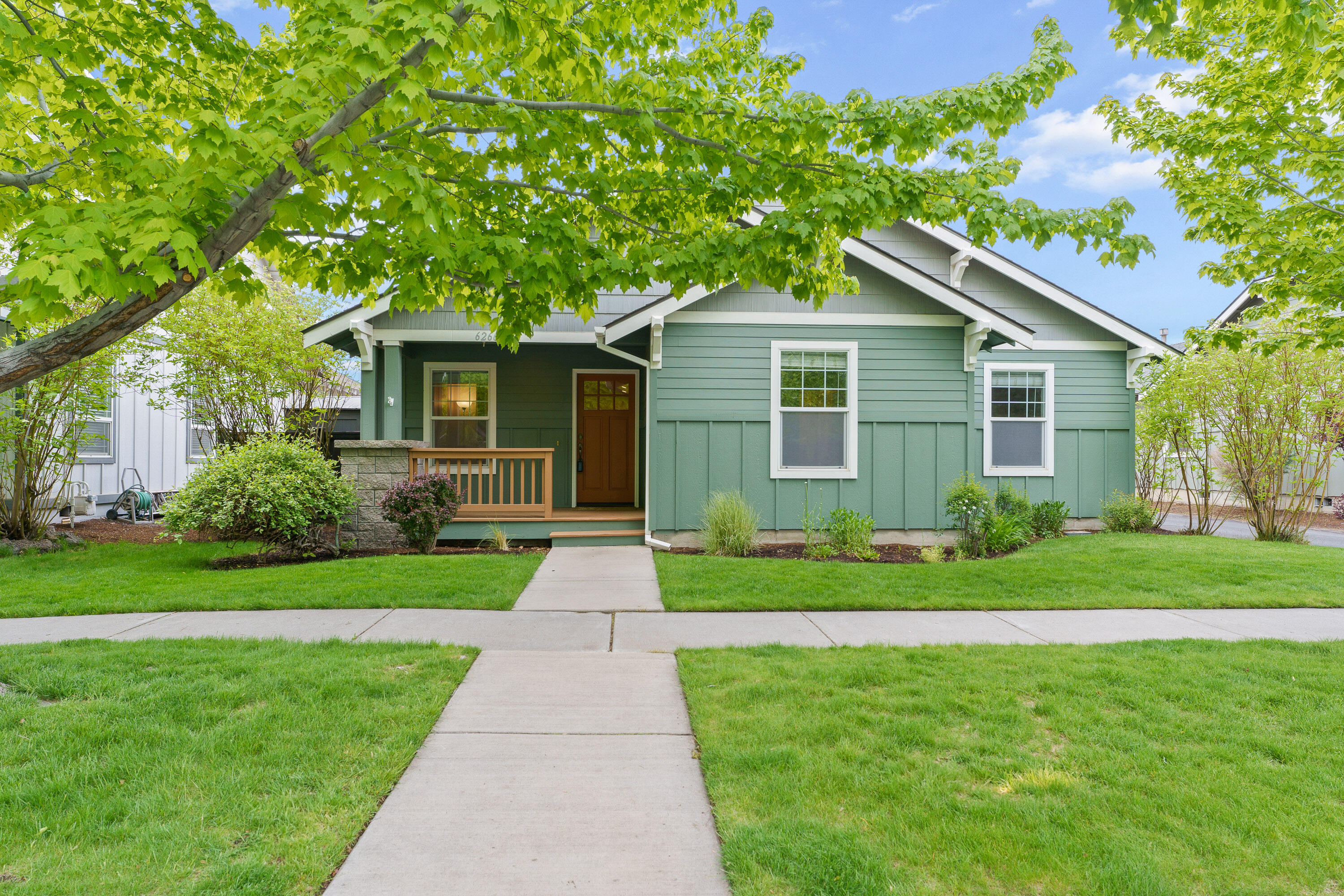 Nestled in a desirable NE neighborhood, this beautifully maintained, single-level home offers 3 bedrooms, 2 baths, and 1,430 sq ft . With an open floor plan, vaulted ceilings, and new carpet, it's perfect for both relaxing and entertaining. The great room flows seamlessly into the dining area, featuring wood floors and fresh paint throughout. Just off the dining room, the kitchen is both functional and spacious, with a door that opens to the backyard—ideal for easy outdoor access. The primary suite is separated from the other two bedrooms for privacy, while the manicured yard with mature trees offers a peaceful retreat. Enjoy some mountain views from the covered back porch or tend to the raised garden beds in the fully fenced yard. Additional features include AC, alley access, a shed for tools, and work benches in the two-car garage. Conveniently located near schools, shopping, medical facilities, breweries, and restaurants. Move-in-ready!