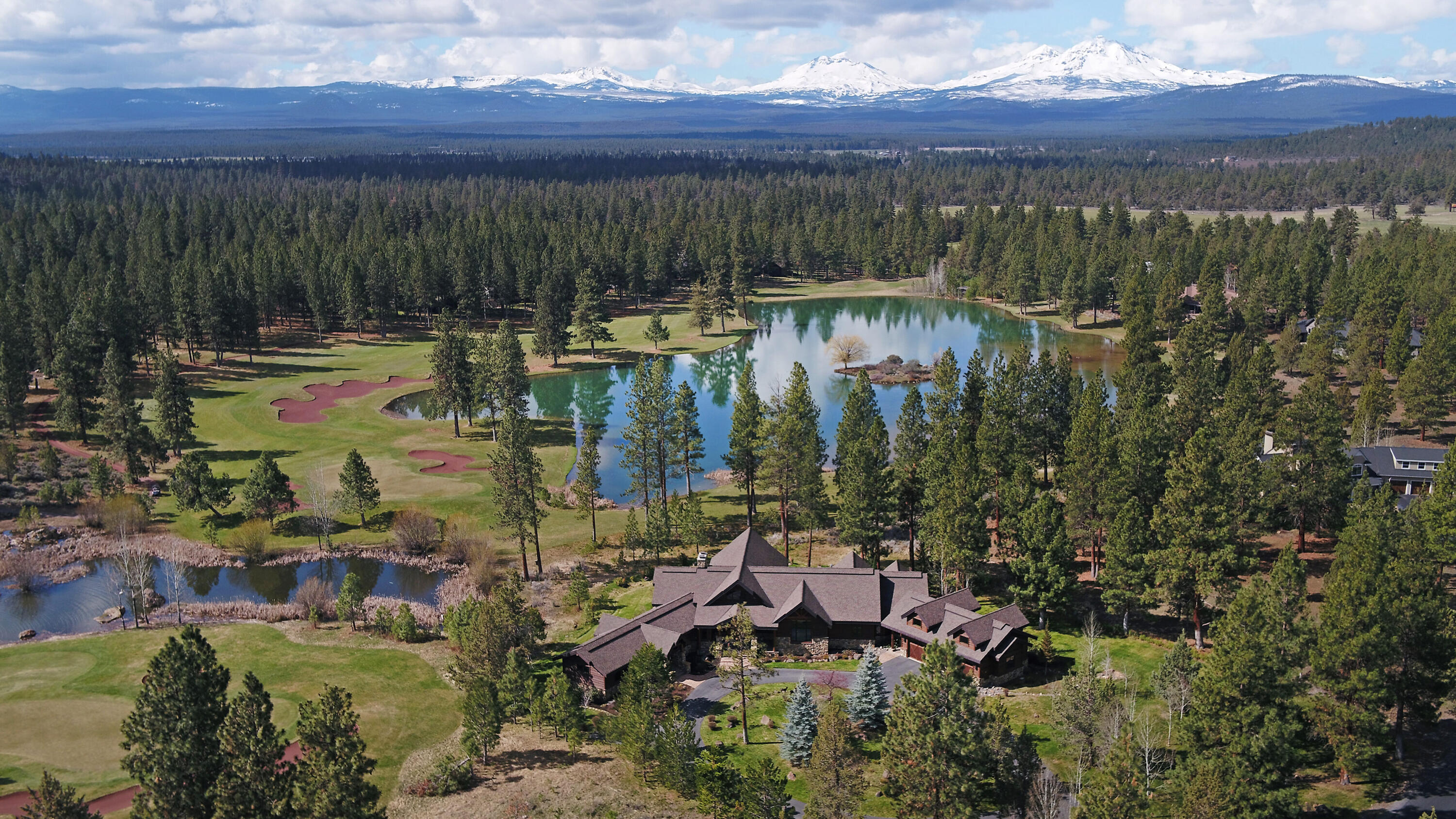 Lodge Style Perfection at Aspen Lakes!  One of the finest homes in Sisters boasting a tranquil waterfront setting with spectacular Cascade Mountain views on an oversized 1.4 acre parcel.  Single story construction featuring vaulted ceilings, indoor and outdoor fireplaces, high end finishes, extensive use of stone and wood, true gourmet's kitchen, two covered outdoor living areas, expansive Master Suite, oversized 3 car garage and two suite guest wing with it's own laundry room.  Great potential for multi-generation living. Offered beautifully furnished!