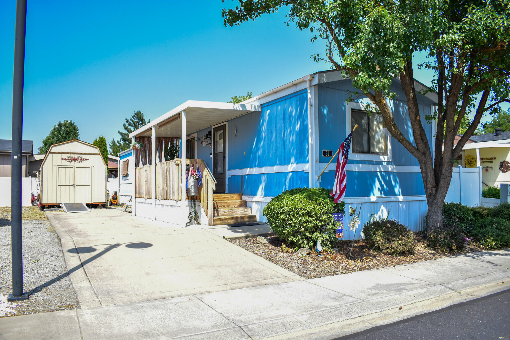 Updated and move in ready, this 2 bed/1.5 bath single wide is located just outside historic Jacksonville! Features include a covered front porch with seating area, large storage shed, spacious driveway for off-street parking, central heat + air, stainless steel kitchen appliances, newer flooring, double-pane windows, medium pet door and a fully-fenced yard. The semi-private back yard has white vinyl fencing, a large deck and small pet area. Interior has a great split floor plan, lots of natural light, plus warm and contemporary colors. Cobblestone Mobile Home Park is a lovely 55+ community, with space rent of $895/mo which includes water, sewer, and trash. Property has had quarterly rodent service last 4 years. Recent home inspection available online.  This one is a must-see and won't last!