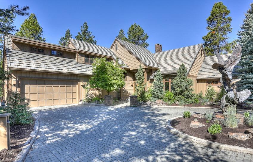 The Timberline Lodge in Sunriver! Exquisite Lodge Style Home like no other in the resort on a big 0.4 acre peninsula lot bordered by N. Woodlands GC and Fort Rock Park! Built by Ross Alexander, 4100sf masterpiece features 4Bd/4Ba, Timberline open beams, arches, stonework fireplaces, slate entry, extensive HW floors, library/den w/FP, covered porch & outdoor kitchen, paver stone patio & new Hot Tub, game/media room w/pool table & large projector screen, custom animal/bird carvings on log banister - Unique+!