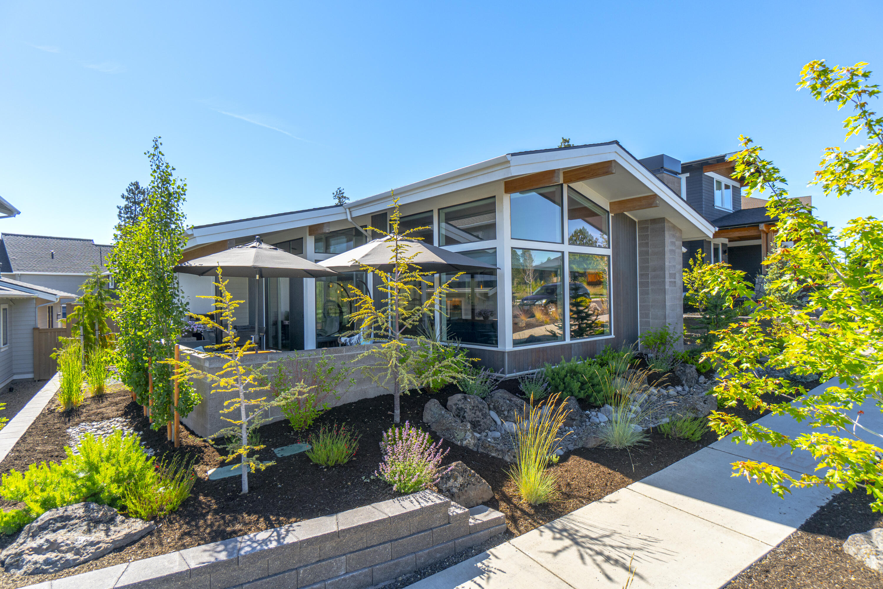 Coveted, lightly lived in, single level mid century modern home in desirable Northwest Crossing. Conveniently located near the new Grove eateries, schools, down town NWX, trails & Discovery Park.  
Built by the highly sought after Structure Development NW, this 3 bed, 2 bath home offers luxurious living both inside and out. The great room floor plan flows beautifully with a large quartz island/breakfast bar, hardwood, abundant natural light, 5 burner gas range, designer touches throughout. Primary has a beautiful walk in tile shower, dual vanity and a walk in closet with full closet system. Laundry room has storage galore, complete with a laundry sink and drying rack. There are many thoughtful updates in this better than new home.   The spacious outdoor patio is perfect for entertaining or just lounging. Complete with Control4 system and extended internet.  
You won't want to miss this special home!