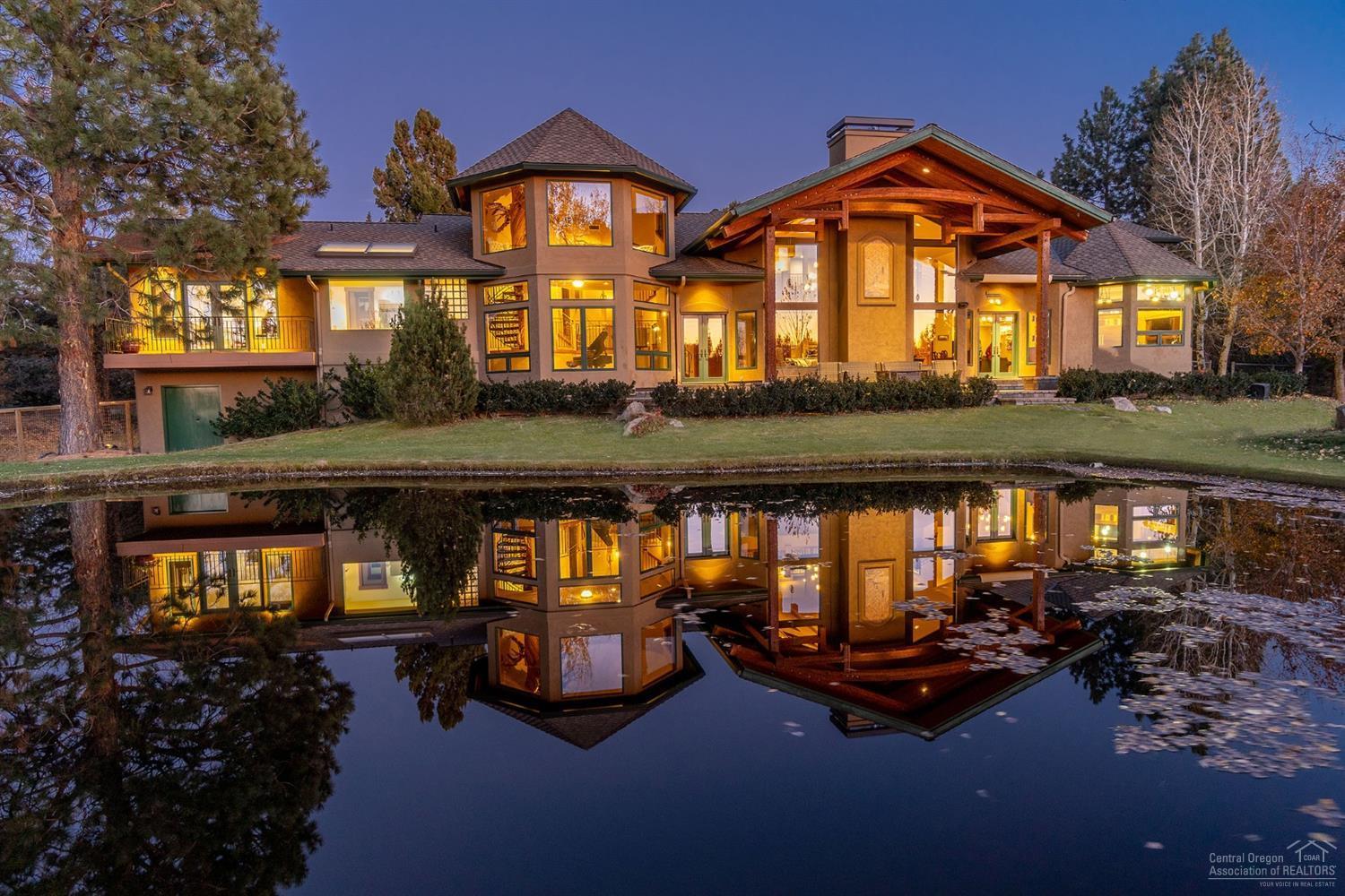 Private, yet just minutes from downtown Bend, lies this stunning mountain lodge home. At the end of meandering drive, old growth Juniper trees frame the entrance, welcoming you into the grand great room featuring custom rock fireplace w/ floor to ceiling windows capturing the amazing views of Cascade Mountain range & glimmering pond. Mountain view kitchen, w/ Wolf & Miele appliances, breakfast bar & island is adjacent to formal dining area & family room w/ cozy fireplace. Luxurious master bedroom & bath w/ heated marble floors, dual sinks, makeup vanity, shower & soaking tub that overlooks the estate & mountain views. Main level also offers 2 addtl bedrooms currently used as game room & Home Theater, as well as guest bath & sauna. Private office w/ bookcase and fabulous deck, upstairs bonus room leads to 2 more guestrooms & 3rd laundry. Majestic juniper tree graces multiple retreats each overlooking the peaceful pond & mountain views. Sunny lodge style home incl. barn & chicken coop<br