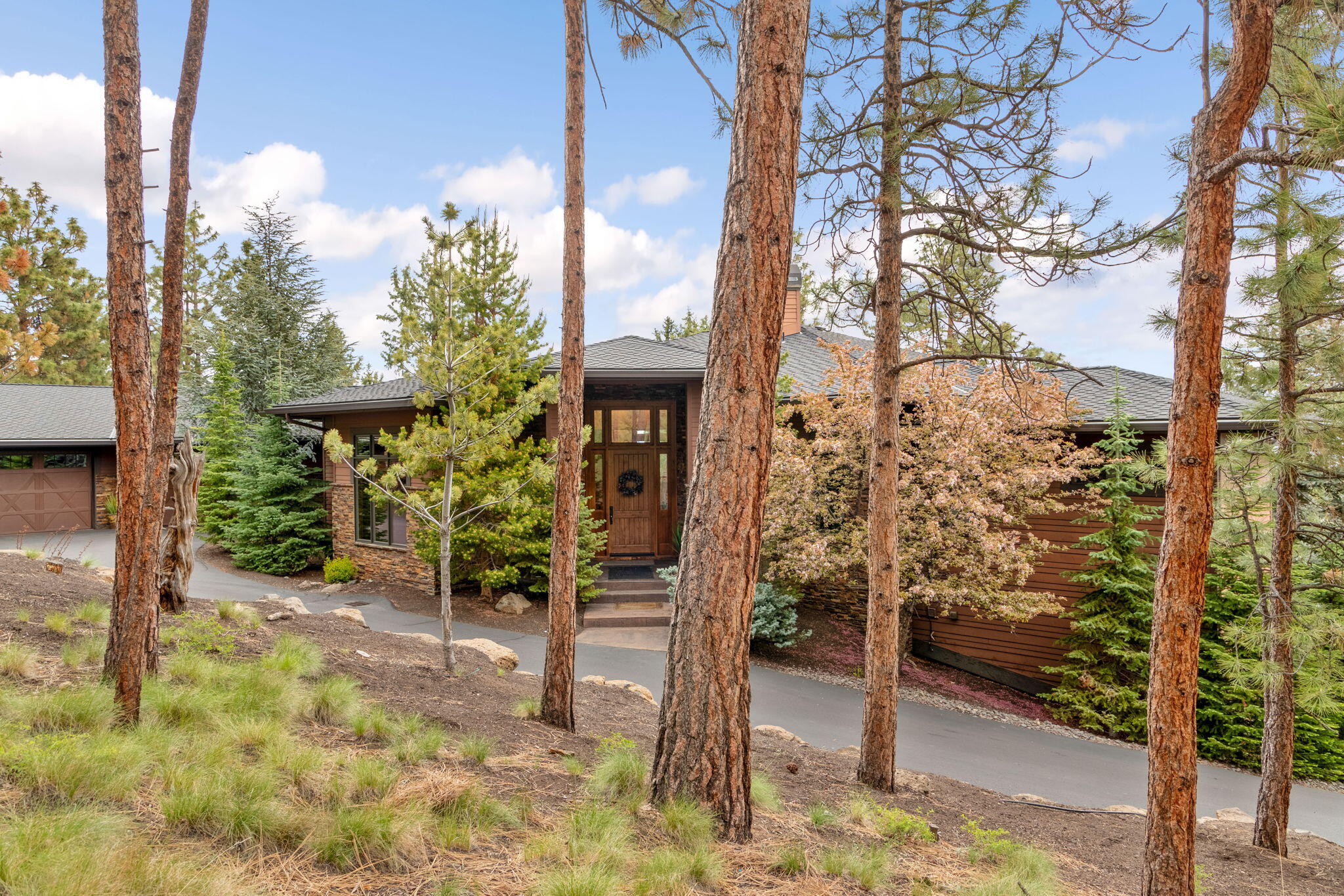 Nestled on Awbrey Butte, this custom-built sanctuary offers the ultimate blend of luxury, tranquility & expansive living space on a private 1.77ac lot. As you step inside you will discover soaring ceilings that create an atmosphere of grandeur & elegance throughout. The main level boasts a spacious primary bedroom w/spa-like bathroom & large custom closet, chef's kitchen, large office/den w/2 built-in desks, laundry room, & an oversized 3-car garage, ensuring convenience & efficiency at every turn! Embrace the versatility of the lower level, offering 2 bedrooms w/their own private bathrooms, a bonus area w/cozy fireplace, another large room that could easily be transformed into a 4th bedroom, wine cellar, large storage area, room for a gym, & a powder bathroom, catering to all your lifestyle needs. The cherry on top of this masterpiece is the stunning views that can be enjoyed from the expansive decks both upstairs & downstairs along with a large, fenced yard. Welcome home!