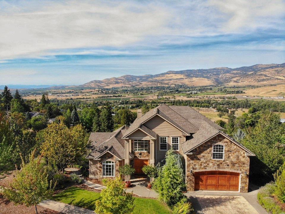 Looking for amazing views & a gorgeous home built by one of Ashland's finest builder Vadim Agakhanov. Beautiful materials & details throughout. Soaring 18' ceilings in main area, walls of floor to ceiling windows. Rich use of wood & stone floors, exotic wood doors, crown moldings, slab granite w/ open kitchen island w/ 2nd prep sink, 5 Star commercial style range w/gas cook top gas & electric wall oven, beautiful cabinets & dbl ovens. Breakfast rm w/sunrise views, formal dining rm, library/media rm + den. Main level master suite w/stone fireplace slider to deck to entry the views, spa like master bath w/ travertine floors, stone lg shower, dbl sinks & walk in closet. Good size bdrms, upstairs w/ lg den, upscale rod iron open railings overlooking living area all located in a private setting next to open space. Studio or Mother In Law space features full bath, kitchen w/dining area, living rm & bedroom + a separate rm great for shop, garden rm or storage.