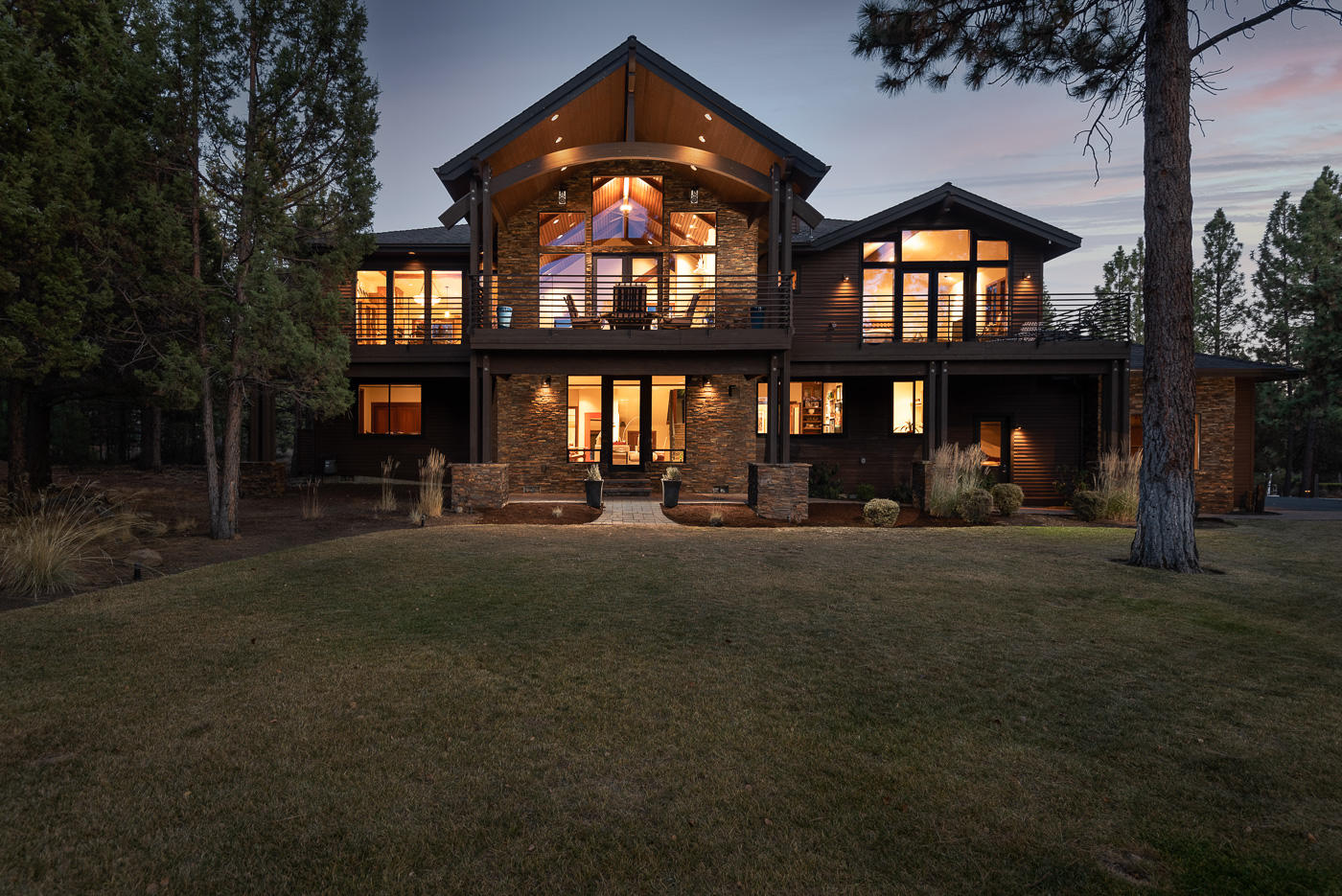 Timeless home on Awbrey Butte built by DeMarco Design & Build. Exquisite finishes of home make it a PNW classic. Grand front entry with floor to ceiling quartzite walls and Hemlock vaulted ceiling through great room. Gas fireplace in great room accentuated by sandstone, woven herringbone and granite mantel.  Open floor plan with Walnut hardwood floors. Chef's kitchen featuring large island, slab granite counters and Alder cabinetry. Dining area with sandstone and herringbone ceiling. Expansive paver stone deck with metal railing and vaulted covered area. Master suite with gas fireplace and large walk-in closet. Master bath highlighted by tile shower with rainwater shower head and soaking tub. Downstairs there are 3 guest suites, office and a bonus room with gas fireplace and wet bar. Nicely appointed fixtures and solid Mahogany doors throughout. Heated 3-car garage with epoxy floors. Meticulously landscaped yard with a sprawling water feature, paver stone back patio and walkways.