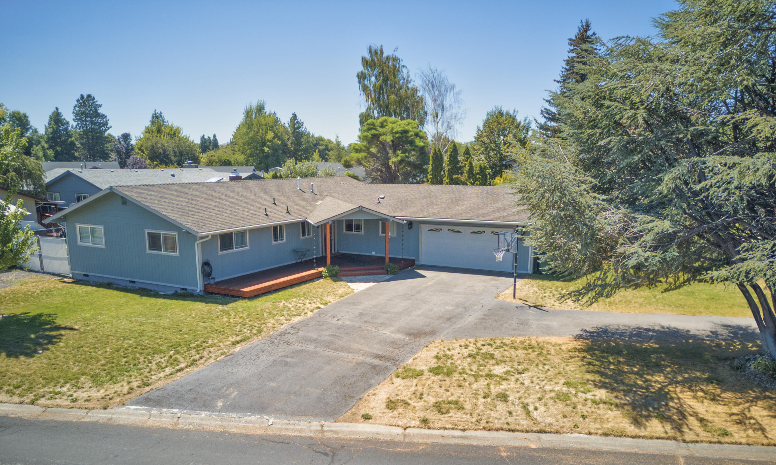 Well-maintained one-level home with a spacious layout and a huge backyard designed for entertaining. Enjoy a covered deck, firepit, and hot tub-ready setup, plus plenty of space to garden or play. Inside, wood flooring flows throughout 3 bedrooms, including a primary suite with ensuite bathroom. The open-concept kitchen connects seamlessly to the dining area, while the oversized living room with a cozy fireplace creates the perfect gathering space. A warm, inviting home ready to enjoy!