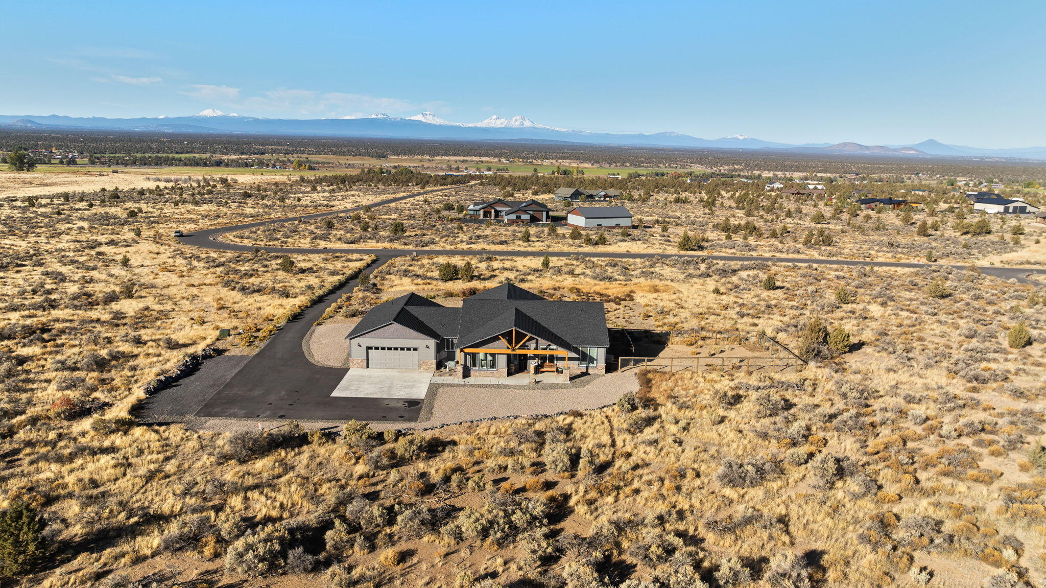 Welcome to the Grandview Ranch. A Refined Country Retreat with Million-Dollar Views. Where the serenity of the countryside meets the grandeur of the High Cascades. Grandview Ranch invites you to slow down & savor the beauty of Central Oregon. Perfectly nestled on 9.94 acres in the desirable Grandview community, this single-level, newly built home captures panoramic mountain views, from Mt. Bachelor to Mt. Hood. Designed for comfort & function, this ADA-compliant home offers 4 bd, 3.5 ba & 2,494 SF of thoughtfully & tastefully finished spaces. Two primary suites feature spa-inspired baths w/ soaking tubs, dual vanities, & generous walk-in closets. The open-concept floor plan flows seamlessly from the great room to covered front & back patios framed by exposed beams, ideal for entertaining or peaceful mornings & fiery sunsets overlooking the Cascades. Located just minutes from the conveniences of the city, Grandview Ranch offers the rare balance of privacy and wide-open mountain beauty.