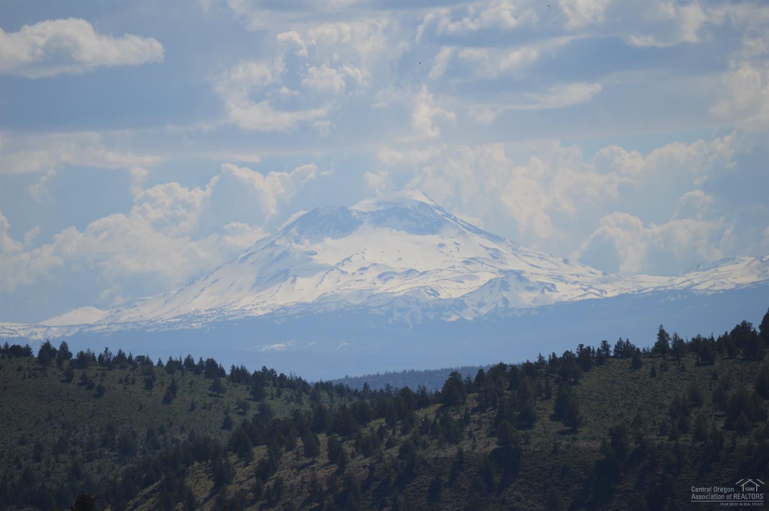 Million Dollar Westerly Cascade views from this 5.2-acre lot with services installed. You must tour this lot to appreciate the private, serene setting. Shared well installed, with separate water meters and recorded agreement. Septic installed for 3-bedroom home and never used. Power to well house. Lot is flat and then slopes to lower level where drainfield is installed. This gives you the unobstructed Cascade and Canyon wall views that very few properties enjoy, while also providing access to lower level. Driveway and building push-out have been roughed-in, so you can let your imagination run wild! A small portion of this properties rear property line intersects with miles and miles of public land, for your recreational use! Access to the beautiful Steelhead Falls on the Deschutes River is nearby. Join this thriving community and enjoy all the amenities; golf, swimming pool, disc golf, tennis/pickleball and river fishing, not to mention the nearby lake sports!
