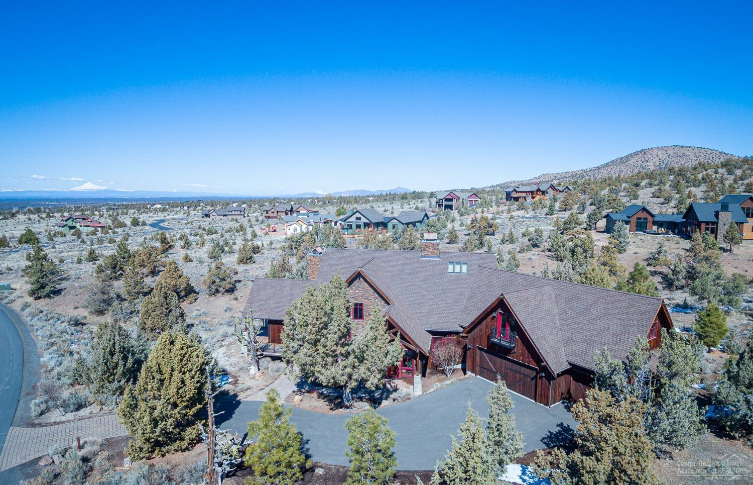 This gorgeous mountain modern home is perched in the perfect location in one of Central Oregon's most highly desired golf communities. Once inside, you are greeted by the large great room with sweeping cascade mountain views, rock fireplace, rustic beam details and beautiful built-ins. The one-of-a-kind wood floors were reclaimed from the officer quarters from the Precidio of San Francisco and bring unmatched character and charm to the craftsmanship of this home. The main level master suite features a private fireplace, luxurious soaking tub and oversized walk-in closet. The options for upstairs are endless. Make your dream theater room or guest suite from the spacious loft space. Come and see this masterfully crafted home in the Brasada Reach community.