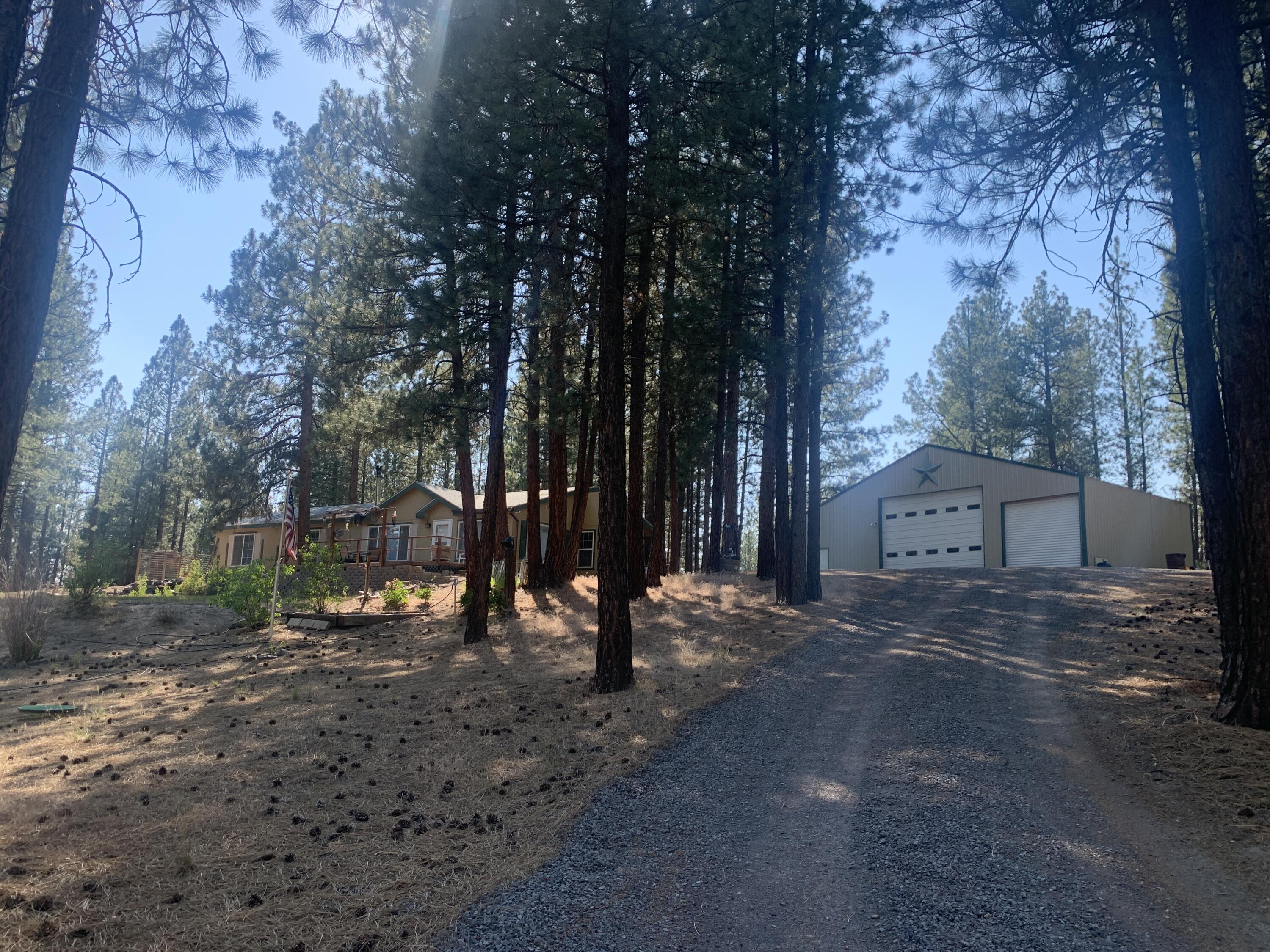 Here's your opportunity for a lovely, move-in ready home nestled in the pines with HUGE, heated shop! Enjoy the serene, quiet privacy of this beautiful 3 bed, 2 bath home situated on 2.48 acres. This single level home features a large, open floor plan with tons of large windows to enjoy nature and the wildlife that frequent the area. The huge primary bedroom with ensuite bathroom boasts a large soaking tub plus separate shower and walk in closet. The large front deck is great for entertaining and enjoying your land just minutes from the gorgeous Williamson River. The massive shop has plenty of room for two cars plus toys and a large RV and also features a separate, heated workshop and loft for tons of storage. Multiple other outbuildings for storage and tractor parking also. Schedule your appointment to see your new oasis today!
