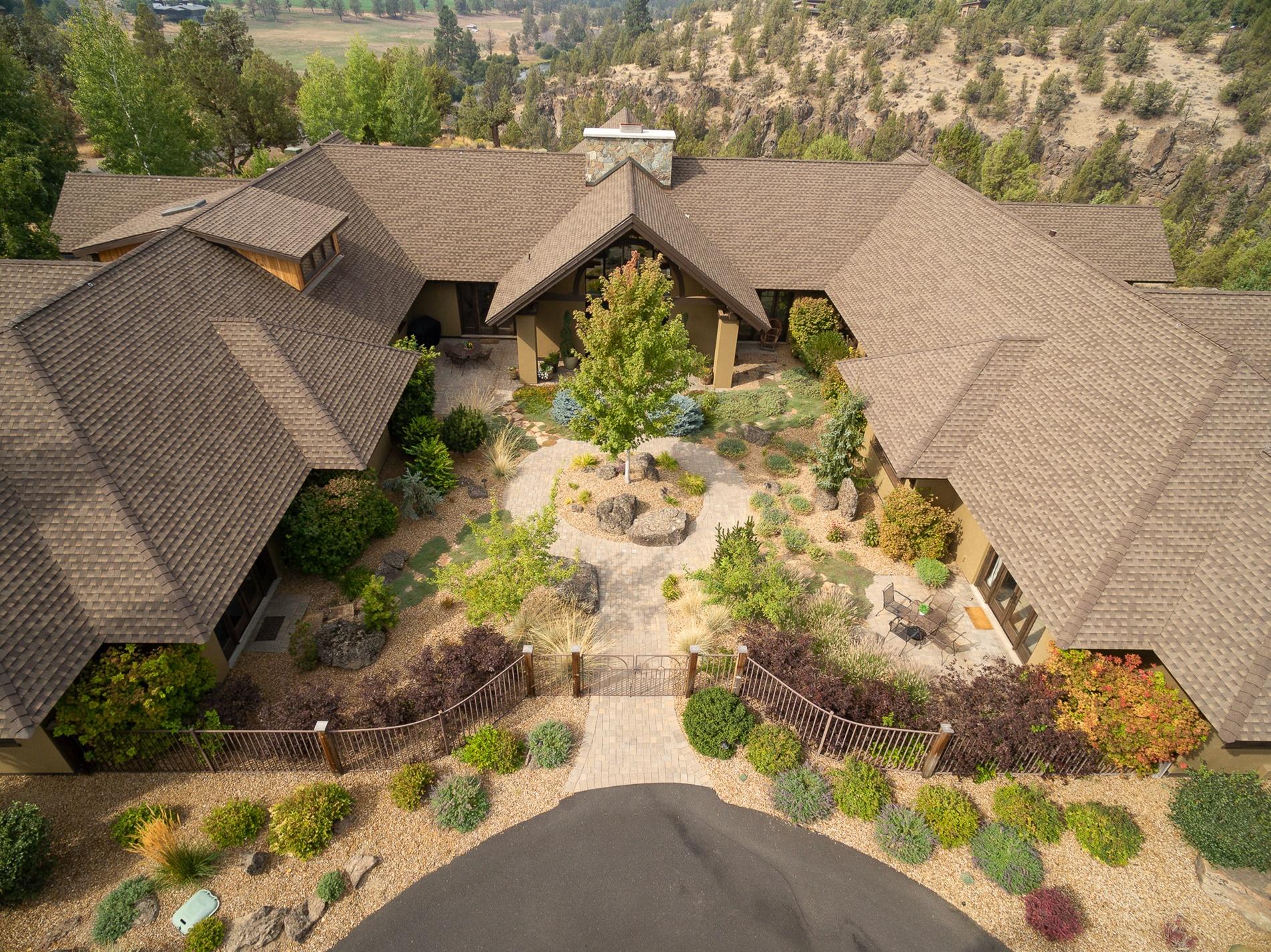 Incredible views of the Cascade mountains and Deschutes River Ranch set the backdrop for this amazing home with barn and guest quarters. Stunning and an entertainers delight from the moment you enter the beautifully landscaped courtyard. The grand 2 sided wood burning rock wall fireplace holds the place of honor in the great room. The wooden beams with iron detail and pine ceilings are a piece or art! The chef's kitchen will temp the most discerning cooks.
Abundant cabinetry, high end appliances and a large island connect with a cozy family room with fireplace, separate dining area. Luxurious master suite with a fireplace and a private patio plus a closet dreams are made of. Jr suite plus 2 bedrooms and an office on main, bonus room over the 3 car garage. Dreamy guest suite over the barn with an upper level lookout. Multiple outdoor areas for relaxing and taking it all in! Deschutes River Ranch offer miles of hiking and
riding trails, private river access and a picnic area.