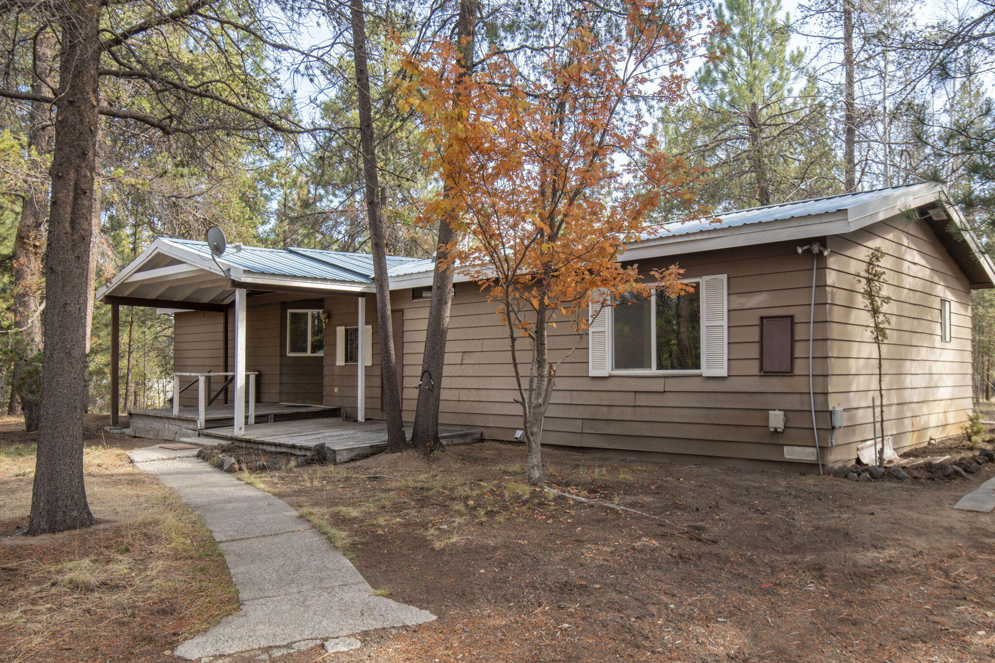Huge Potential with this 1 acre property in Anderson Acres down in La Pine.  Situated in a quiet neighborhood with plenty of privacy, this property has lots to offer.  With an open dining/living area, lots of windows, and vaulted ceilings, this house feels open and inviting.  Newer metal roof and and oversized covered back deck are a huge plus.  Large detached shop with high ceilings provides plenty of space for all of your toys and hobbies.  Ample outdoor parking and enough room for a trailer, RV, boat etc.  With a little TLC and some updating, this property could be a great investment opportunity.