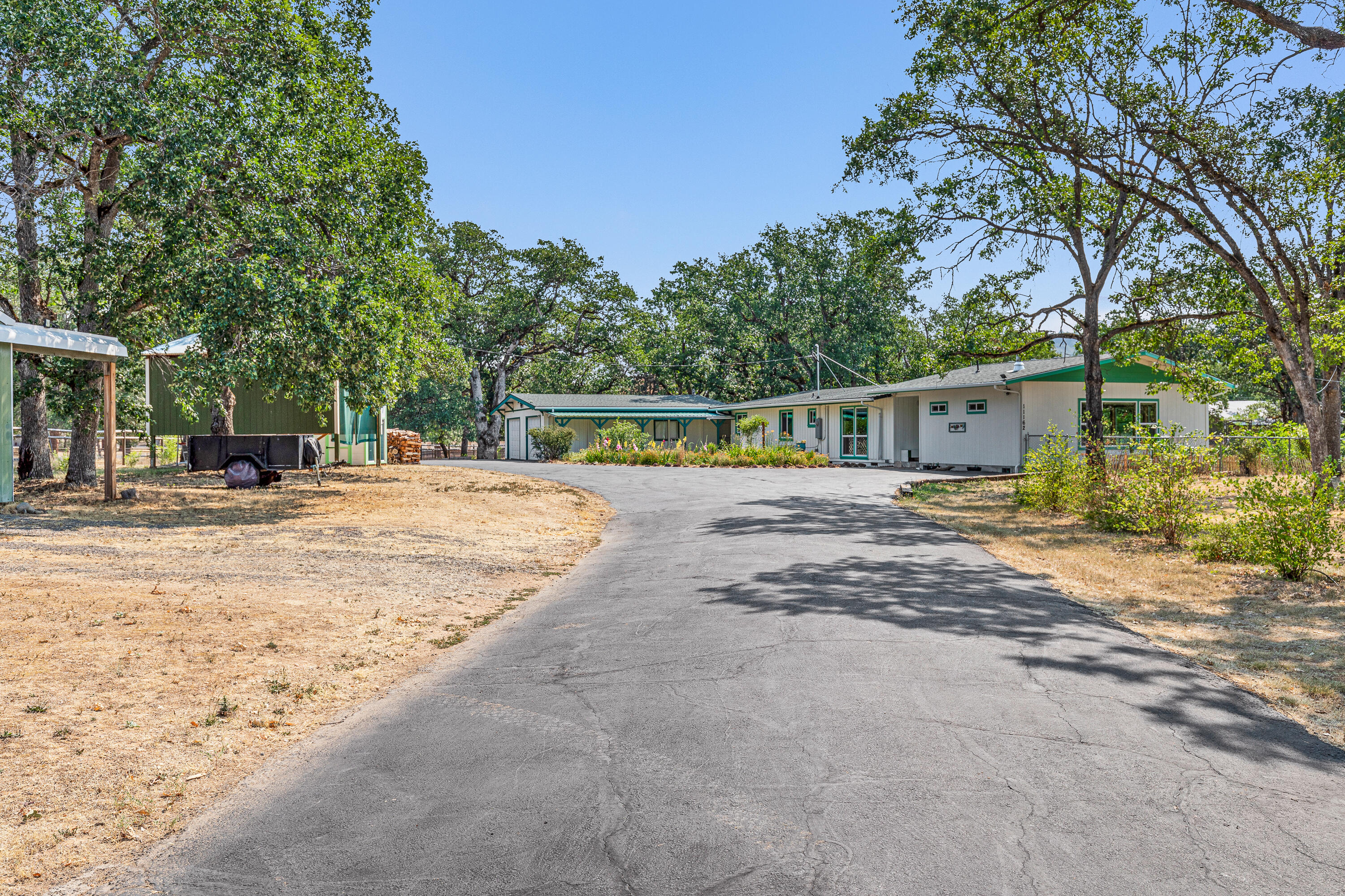 Peaceful updated home that was added on & remodeled approx. 5 years ago w/ a great rm w/coffered ceilings, canned lights, lg windows to take in the views of the countryside, cascade mountains, table rocks & Mt Ashland. Close to hiking trails, Rogue River & Touvelle Park w/boat ramp. Updated kitchen w/stainless steel appliances, lg island w/granite counters, luxury vinyl plank floors. Formal dining rm, living rm w/brick floor to ceiling wood burning fireplace. Vaulted wood ceilings in dining rm, kitchen, office/flex rm & all bdrms. 2.5 baths have been updated w/tile showers. Oversized 2 car finished garage w/work bench & cabinets + lg barn/shop that can hold 4 cars, green house & chicken coop. Fenced in area for garden beds, fruit trees & pasture area. Perfect mini ranch close to town w/over 70 oak trees & gated entry.