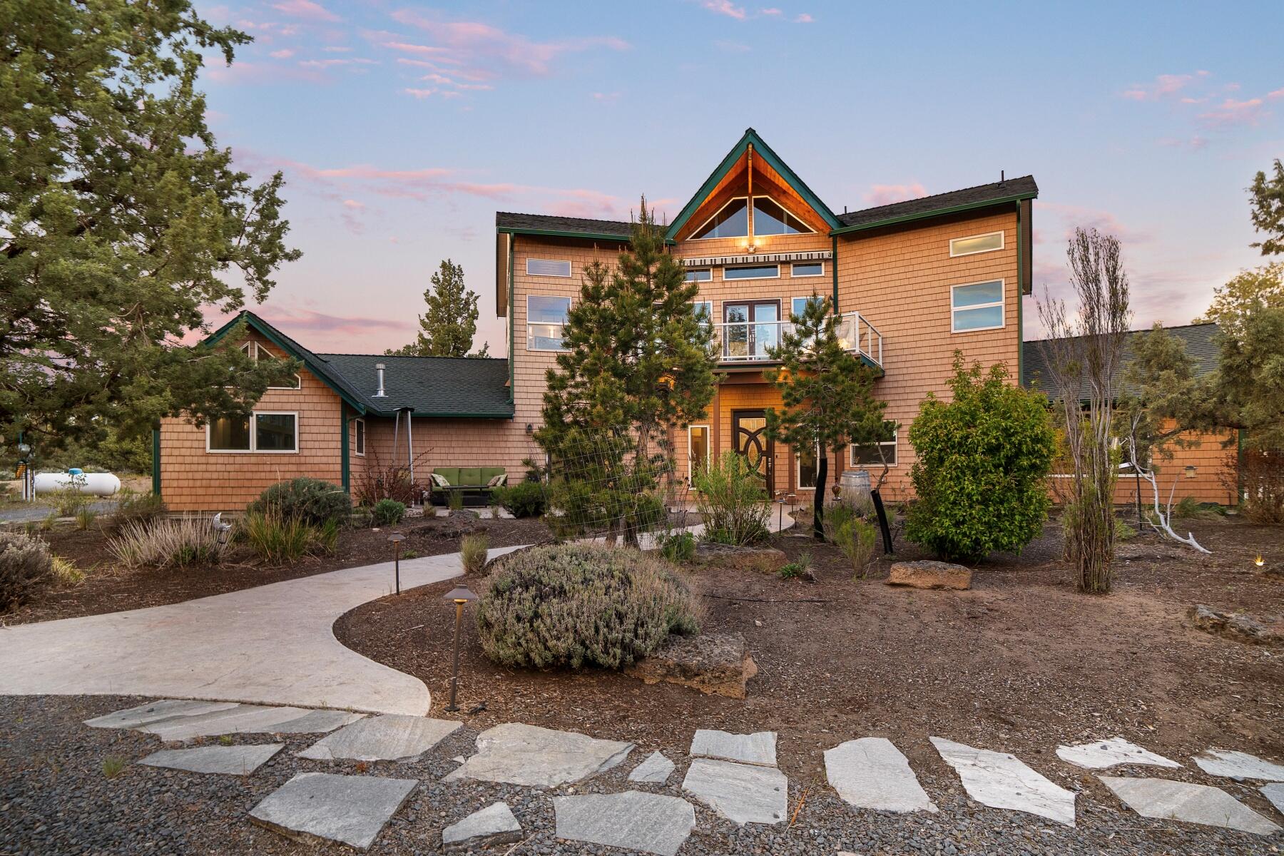 Set against the picturesque backdrop of Bend, this one-of-a-kind home offers a blend of seclusion, versatility and easy access to outdoor activities. The main floor is designed for ease of living with ADA accessibility and a spacious room on the first level which can be effortlessly transformed into a primary suite with double walk-in closets. On the other wing of the main level, enjoy a recently updated indoor saltwater pool, sauna and hot tub. Recent updates include fresh paint, new carpeting, cross-fencing, an elevator lift, new mini-splits and more (see the attached upgrades list). Spanning nearly ten, low-maintenance acres, the property includes several RV hookups and a detached structure complete with a kitchenette, w/d, outdoor patios and its own driveway - an ideal guest house or home office. Just minutes from downtown Bend and close to mountains, trails, river, and outdoor recreation, this high desert sanctuary offers a unique combination of convenience and tranquility.