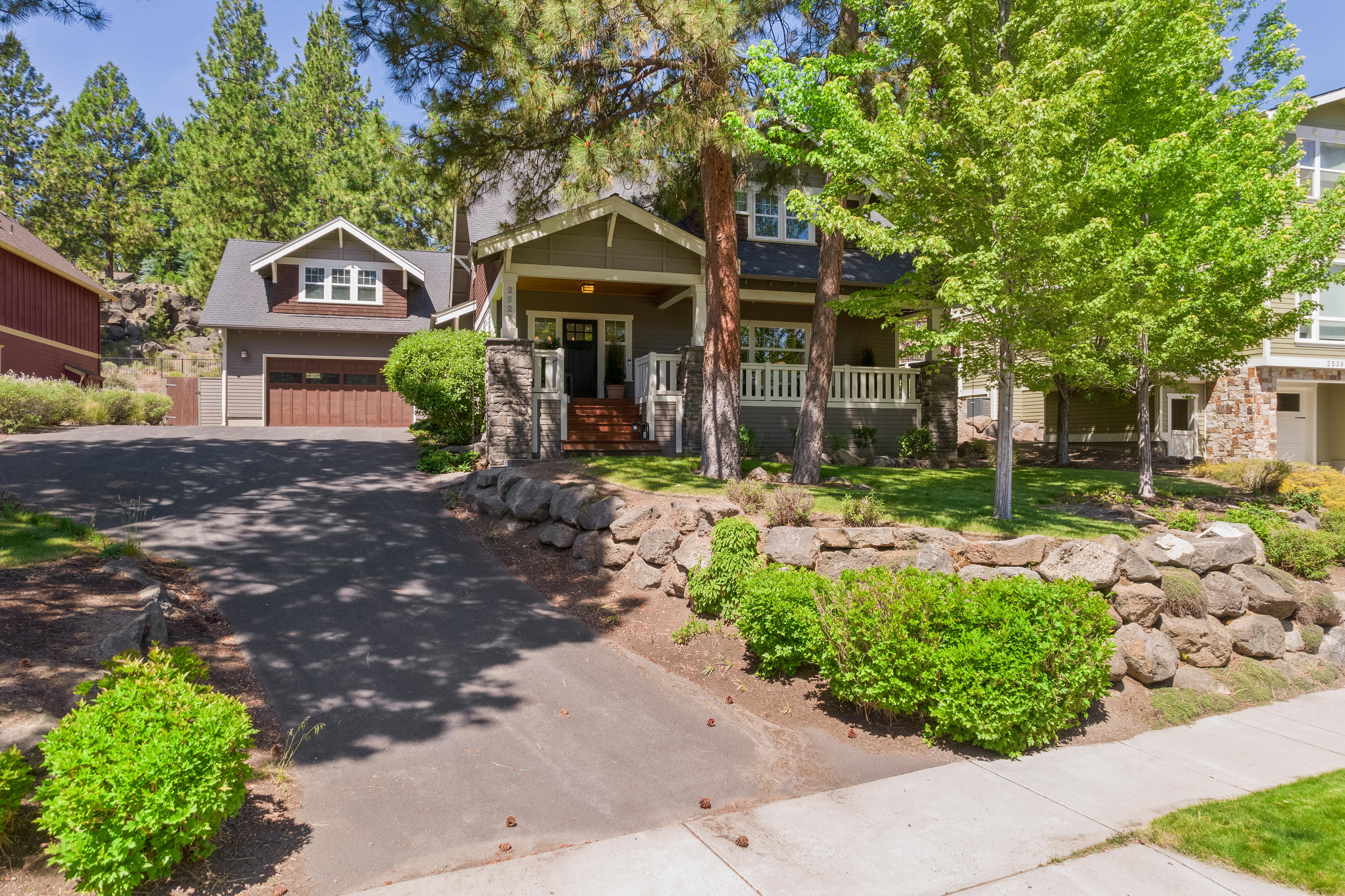 This home is truly magazine worthy! The interior offers quintessential modern farmhouse finishes that will take your breath away! Main level features a dining area with wood paneled ceiling, and spacious kitchen with quartz countertops, new lighting, farmhouse sink, & island/breakfast bar. Main level also includes a bedroom/den with built-in Murphy bed, full bath with tile shower, & living room with custom built-ins surrounding a cozy fireplace. The remaining bedrooms are upstairs, including the master suite with his & hers walk-in closets, and a beautifully appointed master bath with a clawfoot tub, tiled shower, & marble accents. The re-designed laundry area is gorgeous! Giant bonus room is featured above the garage w/ vaulted ceilings & fireplace. Light and bright with lots of windows throughout! Enjoy the summer nights on the covered front porch or the back patio around the stone fireplace. Situated on over 1/4 acre, nestled in the trees on one of the loveliest streets in NW Bend!
