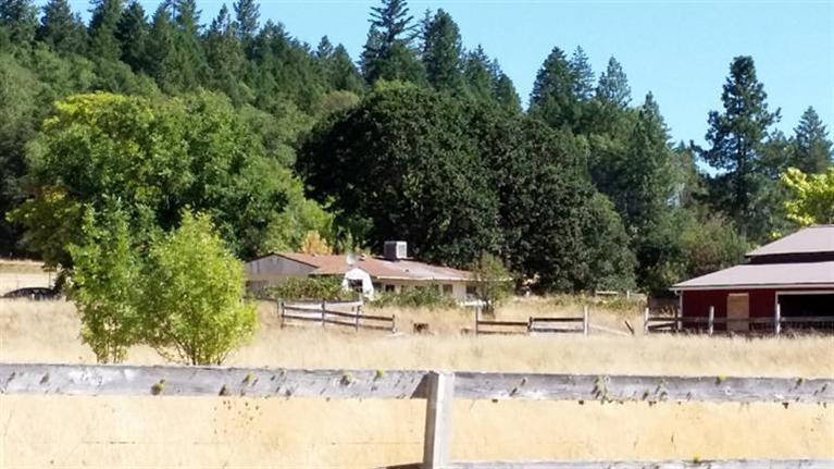 Great building site, 2.9 flat, level, useable acres. Well & septic, a 1971 doublewide roofed over, 720 sq ft mobile home, 2 bd 1 ba, needs lots of work or remove & build new. Large red 6 stall barn. This property could be cleaned up & brought back to a beautiful pastoral setting. Storage shed. Close to Findley Bend Park & fishing area on the mighty Rogue River. Seller to create easement to 1 well over TL 400 to benefit TL 402 through escrow. Motivated Seller says, make offer.