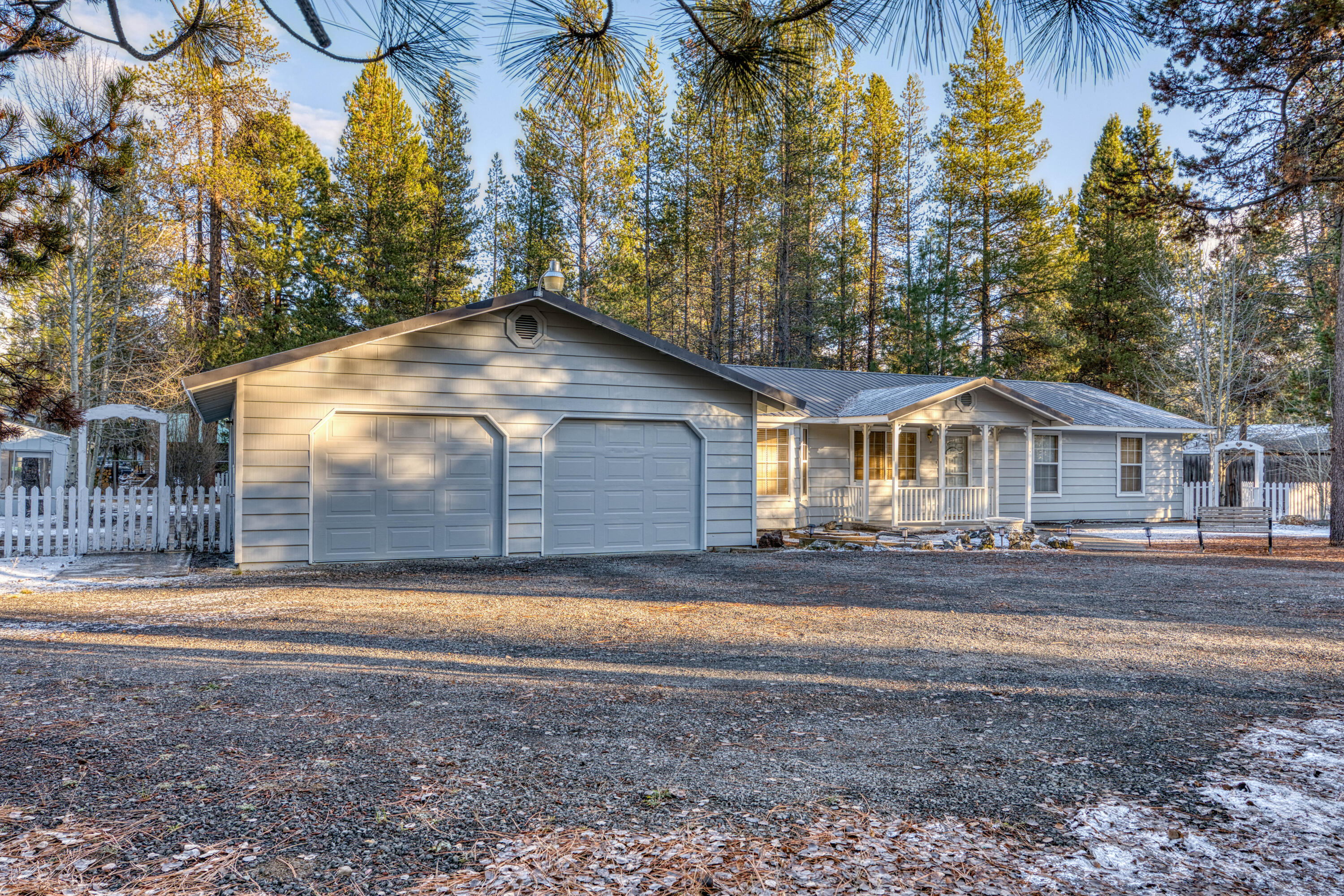 Fresh exterior paint on home and outbuildings!! This exceptional ranch-style home boasts 4 bedrooms, 2 bathrooms, and spans 1780 square feet, nestled on approximately 0.95 acres of land. There are countless noteworthy features to highlight - from its large living room, split living layout to the charming pine wood floors, spacious kitchen, and dining area, to the generously sized laundry room with a large pantry. The built-in bookshelves in the living room offer a convenient and inviting space to curl up with a good book and enjoy a great seating area. The attached oversized garage offers ample storage space with numerous cabinets, while the outdoor space features paths and walkways, several outbuildings, wood storage, and an RV cover. The property is conveniently situated on a .95 + or - corner lot just off paved road and close to many recreational areas! Really must see to appreciate!