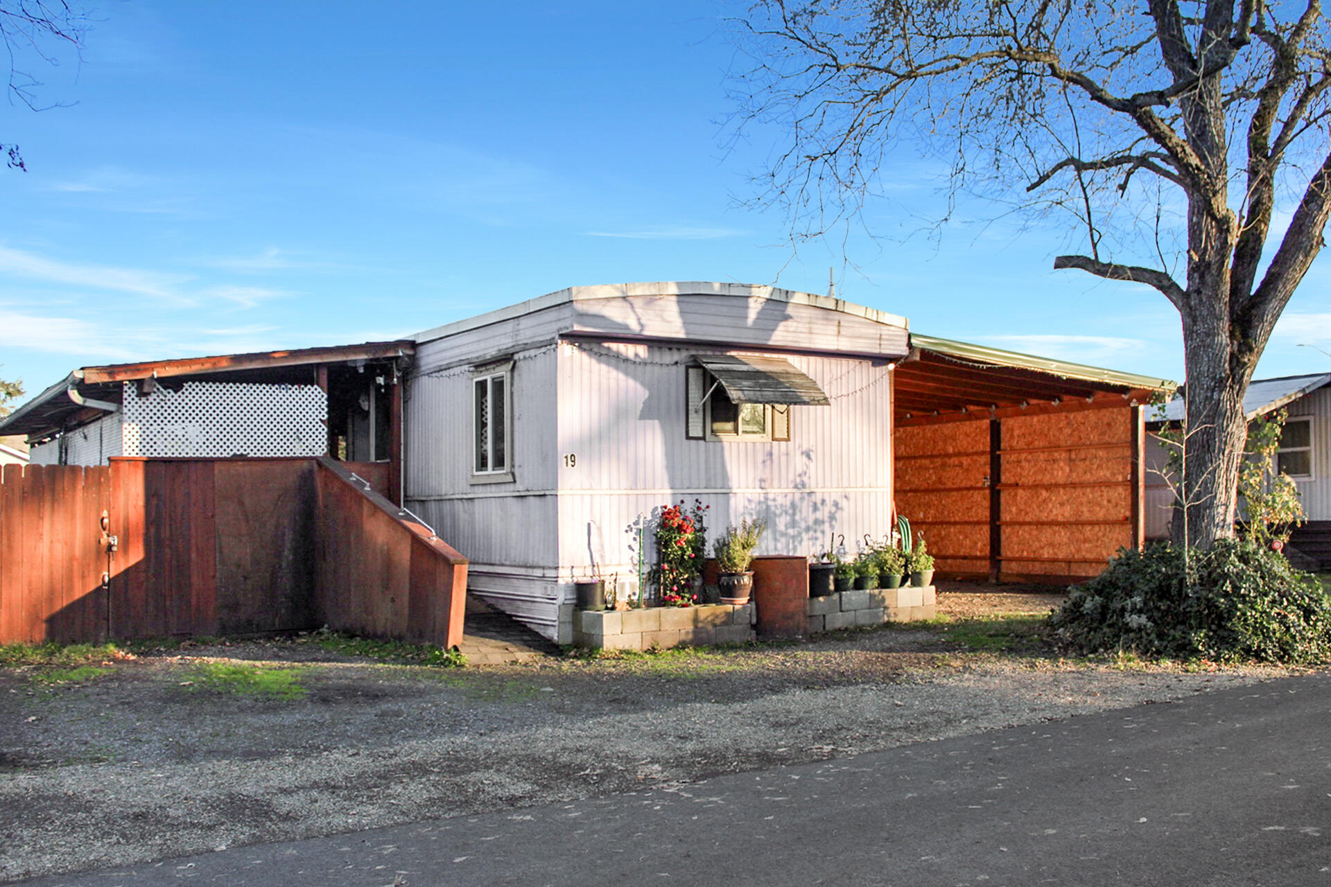 1975 Single wide manufactured home located in the Antelope Acres manufactured home park. Home has received documented weatherization and energy-efficiency improvements, including upgraded insulation, air sealing, ventilation improvements, and installation of a ductless mini-split heat pump. Interior reflects a classic manufactured home style with a functional layout and opportunity for cosmetic updates. Property includes a detached bonus room offering flexible use such as office or hobby space. Property also has been gardened and has many fruit trees planted. 
Large Carport with shelving provides the extra space for parking and storage. Manufactured home is located in a park and is subject to space rent and park approval.