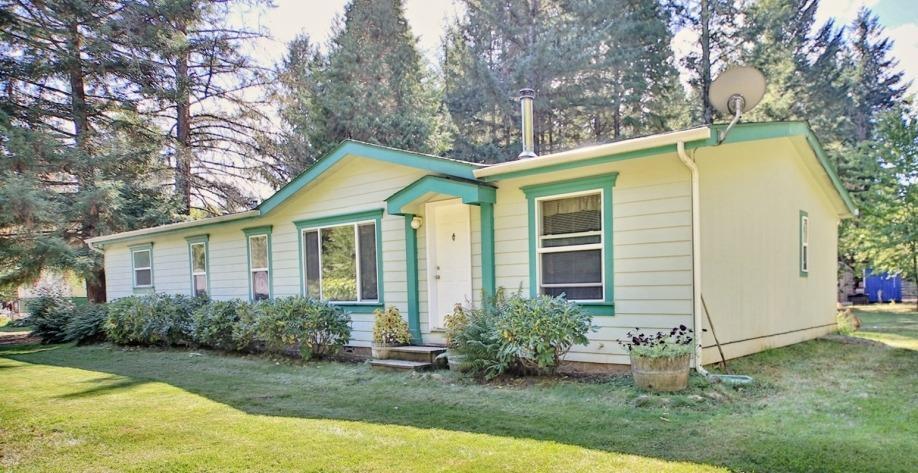 Your escape to paradise is here! Dreaming of privacy, peacefulness, and a picture perfect rural setting with a lovely home? This immaculate 1620 square foot 3 bedroom, 2 bath home features a bright open floor plan with vaulted ceilings and lots of windows to enjoy views of tall trees, flowering shrubs and your own little haven. You'll enjoy the comfortable one level with a spacious living room with certified woodstove, dining area, kitchen with pantry, breakfast nook, family room and large laundry room. The 3 bedrooms include a Master suite with walk in closet, private bath with double sinks, soaking tub and separate shower. Gated and fenced property, detached shop with 2 carports, storage shed, fenced garden area, fruit trees, lawn, shrubs, flowers, an ornamental water feature and room to park your RV, boat and extra vehicles. Immaculate and move in ready!!!