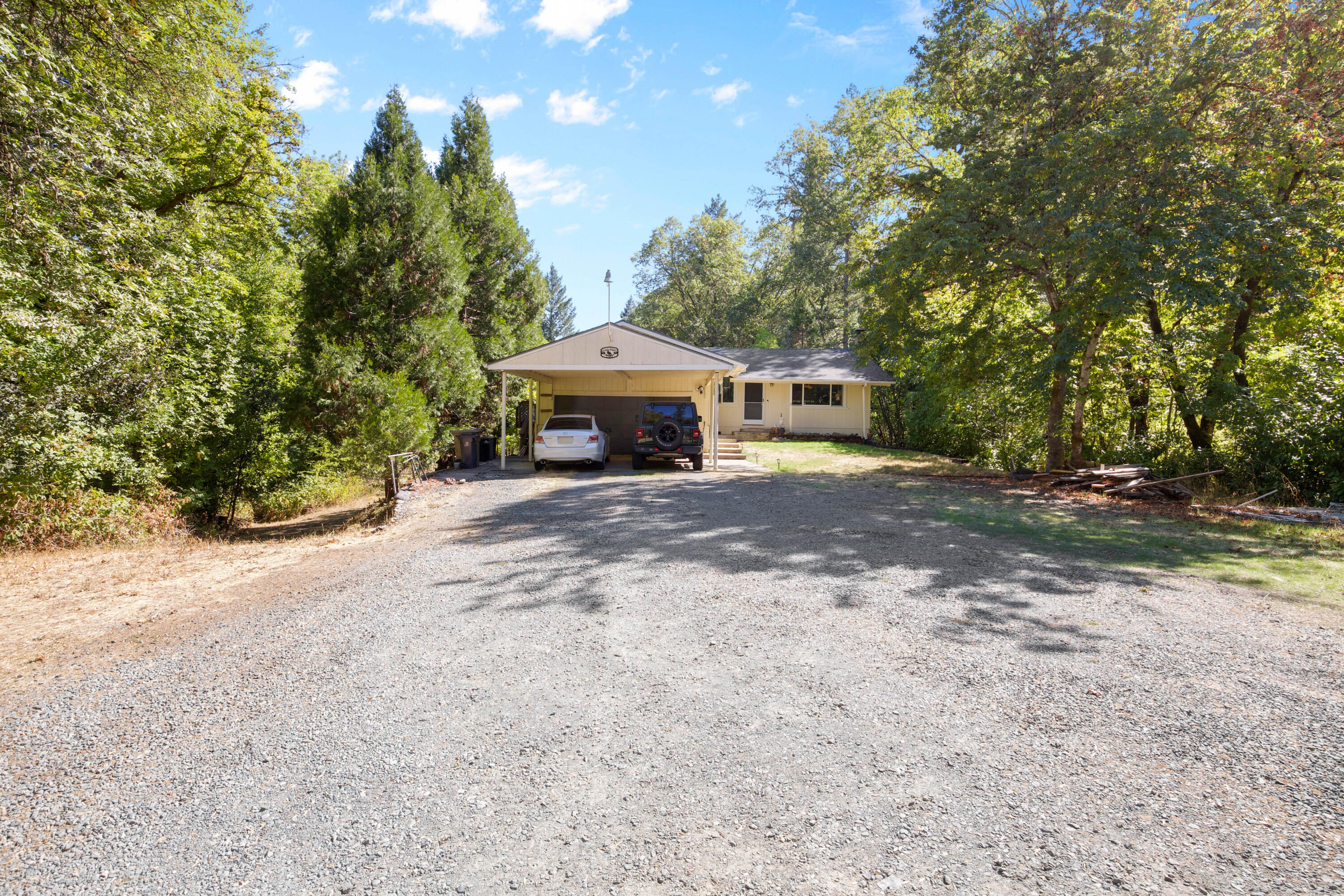 Don't miss this opportunity to own this large 2.85-acre property with 500ft of year-round creek frontage, that brings in the joys of the country living and charm. Plus all the major items are taken care of for you before you move in including a BRAND NEW roof, updated bathroom features, a brand new septic, a new water tank, and new Ion Pro AirCat filtration system for water with a well that tested at an average of 18 GPM for four hours in 2022. You can also enjoy water rights with this property as well for your fruit trees and livestock etc. This is a beautiful property and a MUST SEE!