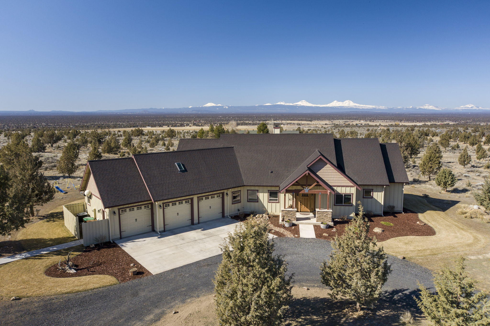 This custom-built home perched on 4.97 acres overlooks beautiful cascade mountain views. Equestrian paradise with a 1,728 sqft horse barn complete with 2 stalls, tack room, drive through breezeway & a covered lean to for additional storage. Minutes from Brasada Ranch. The 3,227 sqft house features Luxurious kitchen with live edge granite countertops, Knotty Alder Cabinetry complete with countertop and kickboard lighting. Scraped hickory hardwood leads into the carpeted great room where generous windows capture the expansive cascade scenery. Solid hardwood doors create a private oasis for the ground level master suite with custom cove ceiling lighting, large soaking tub, dual shower, and a walk through closet. Head upstairs to the two bedrooms and Jack & Jill bathroom and on into the private theater. This private backyard patio is great for outdoor entertaining with a fabulous built in firepit. Polk Audio speakers inside and out, including the barn.