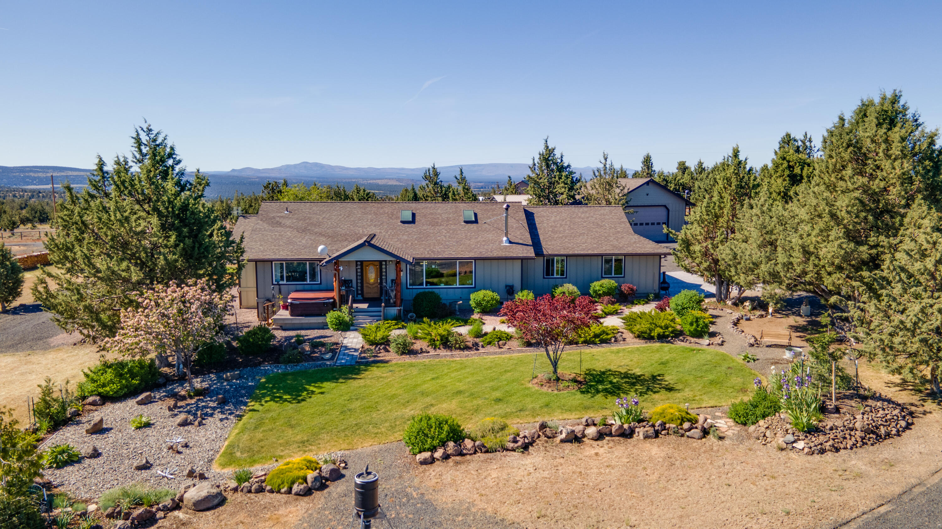 Fantastic views from this hilltop home overlooking Prineville and the Ochoco Mountains. The spacious home has an open floor plan with great room and large kitchen. Picture windows capture the beautiful views and create natural lighting for the home. Attached 2 car garage and separate 30 x 32 finished and insulated shop with high ceilings and concrete floor. The 12 x 17 storage shed is fully insulated and has power and a concrete floor. The steel carport is 20 x 40 with gravel floor. The landscaped grounds are well kept and set up with automatic sprinkler and drip irrigation systems. Domestic well produces 37 GPM. Enjoy entertaining on the covered deck and gazebo. Raised beds for gardening. Paved, private driveway.