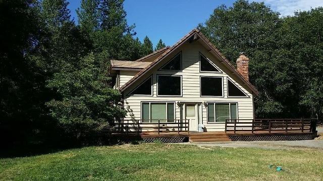 Your perfect chalet in the country. Just minutes outside of Grants Pass is this custom built lodge style home, with its own working shop. Grand cathedral ceilings with balcony. Master bedroom on the main floor with open kitchen that is great for entertaining. Very well built with carport area and enjoy the deck that looks into the grassed treed area. Nice large windows bring in the nice light from the sun. Two accesses to this home, one for the shop and one for the house or use both. The shop is fully contained with an office/room upstairs so a home business or hobbyist will enjoy this. There is a setup for another home/manufactured that has its own hookups and utilities. All flat land and nicely treed this stand out house will make someone happy to call home. Ready for move in.