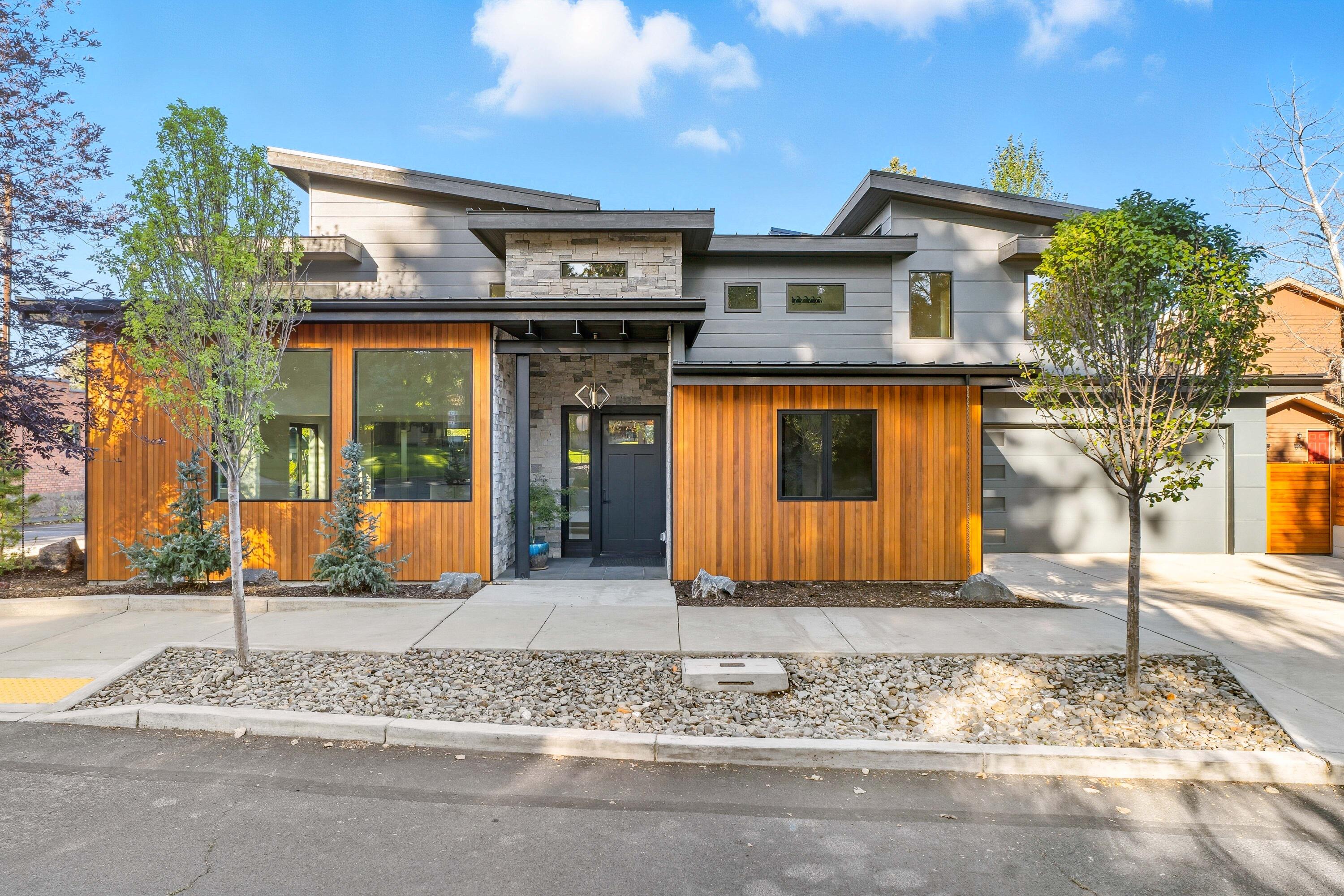 Discover modern living - a stunning new construction near downtown and Drake Park. Set on an oversized corner lot, this 3,093 sq ft home (plus 466 sq ft garage) offers 4 bedrooms, 3.5 baths, and a bright, open layout designed to connect seamlessly with the outdoors. Walls of windows fill the living spaces with natural light, while tiled patios and covered decks invite year-round enjoyment. The chef's kitchen features maple cabinetry, quartz counters, custom hood, island, pantry, and premium finishes throughout. A rare opportunity to own a contemporary home in Bend's prime westside neighborhood reimagined with timeless design.