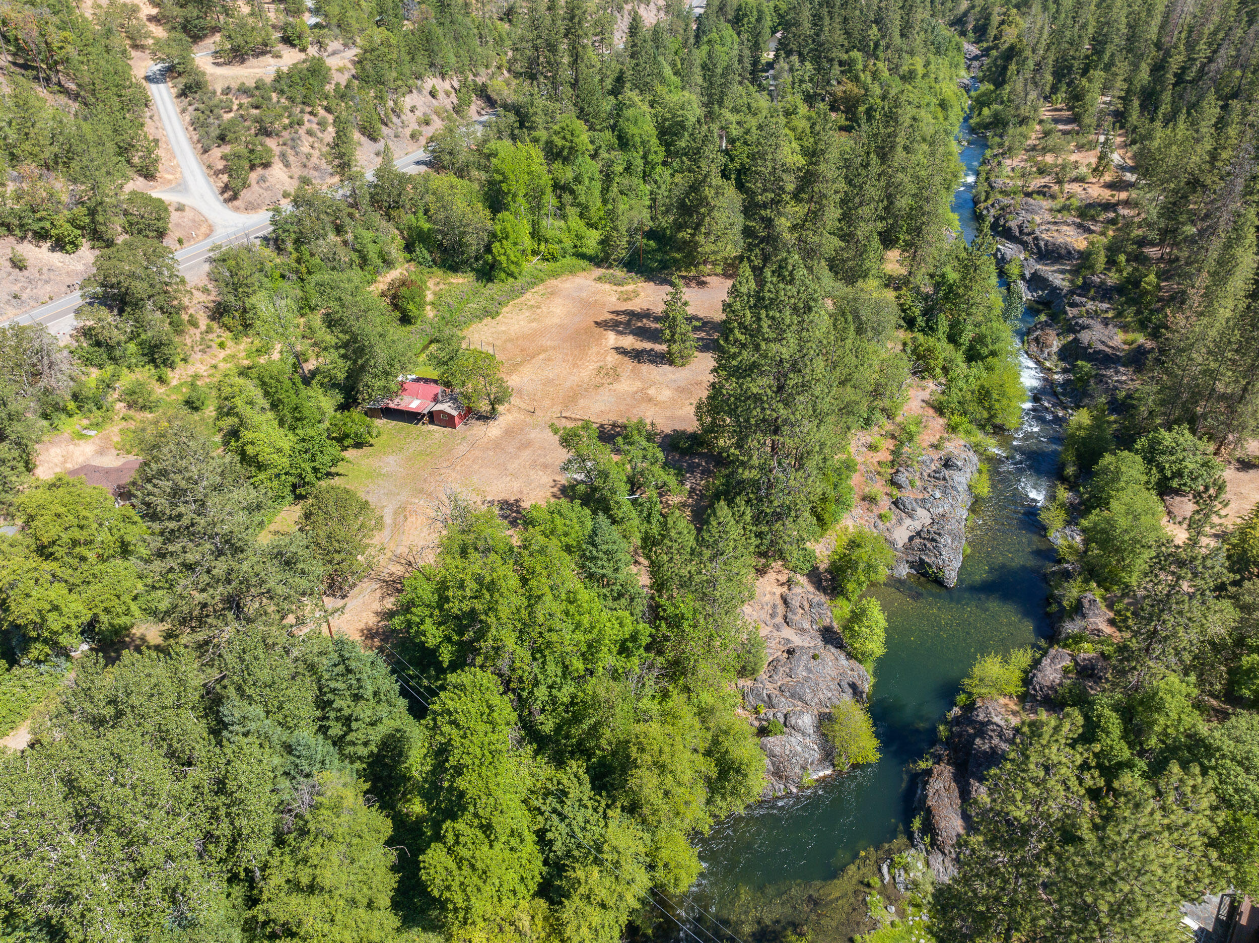Private Applegate River Retreat. This property boasts over 7 acres of private flat acreage, approximately 850 feet of direct river frontage with massive rock formations, fire pit and deep swimming holes.  The 3-bedroom home is well maintained with new carpet, linoleum, roof, extensive decking, updated well, fresh interior paint, additional studio with kitchenette, 5 full acres of irrigation and outbuildings.  Home sold partially furnished.  Just 20 minutes to downtown historic Jacksonville, Oregon.