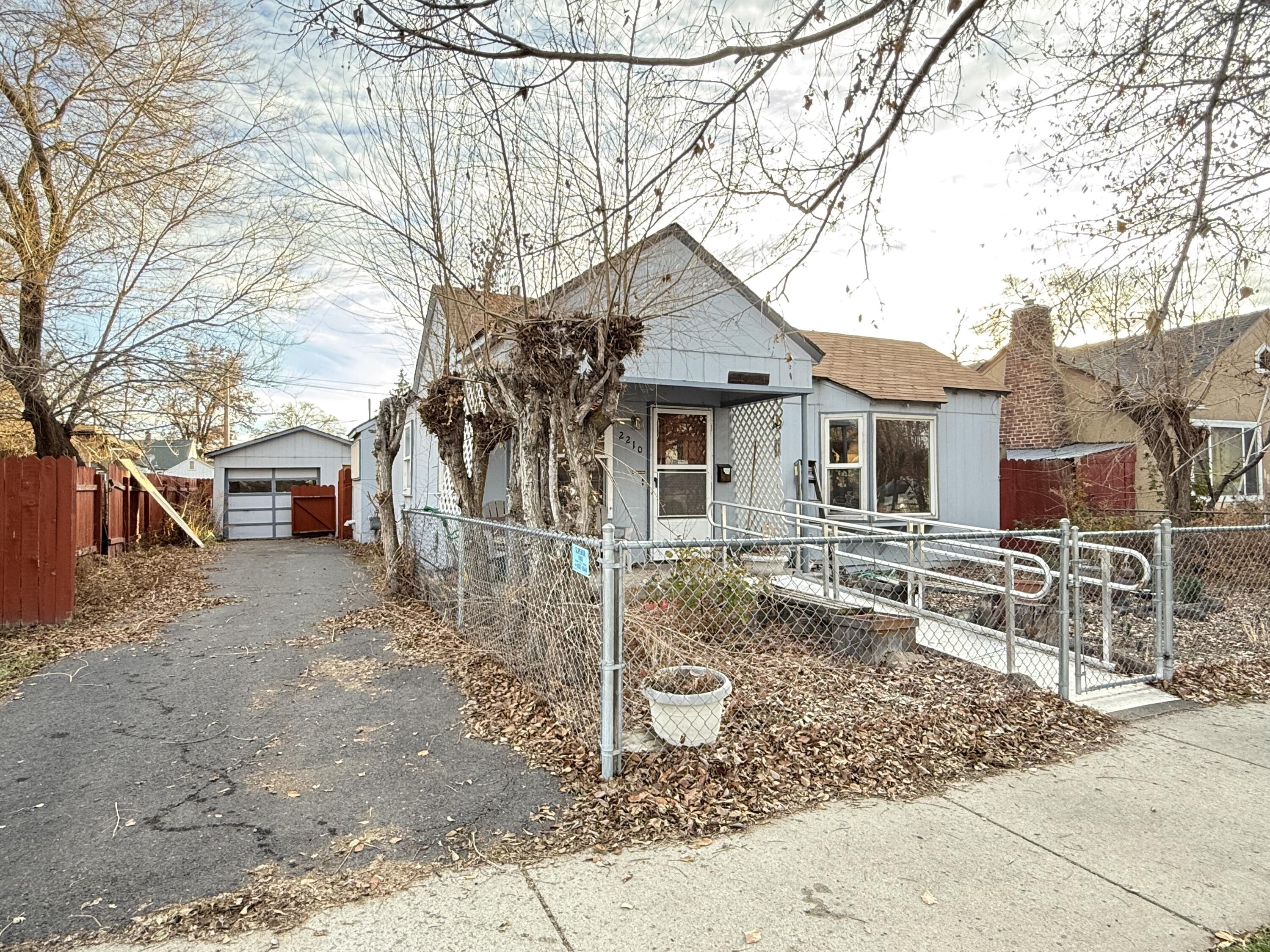 2 bed 1 bath home, featuring 2 detached garages, one single door and one oversized tall double door shop! Home has a fairly open floor plan with 2 separate living or family rooms. The shop is oversized and presents a number of opportunities. While the home could use some updating, it has great potential to someone who is willing to make some updates on their own, and has a lot to offer! Schedule your showing today.