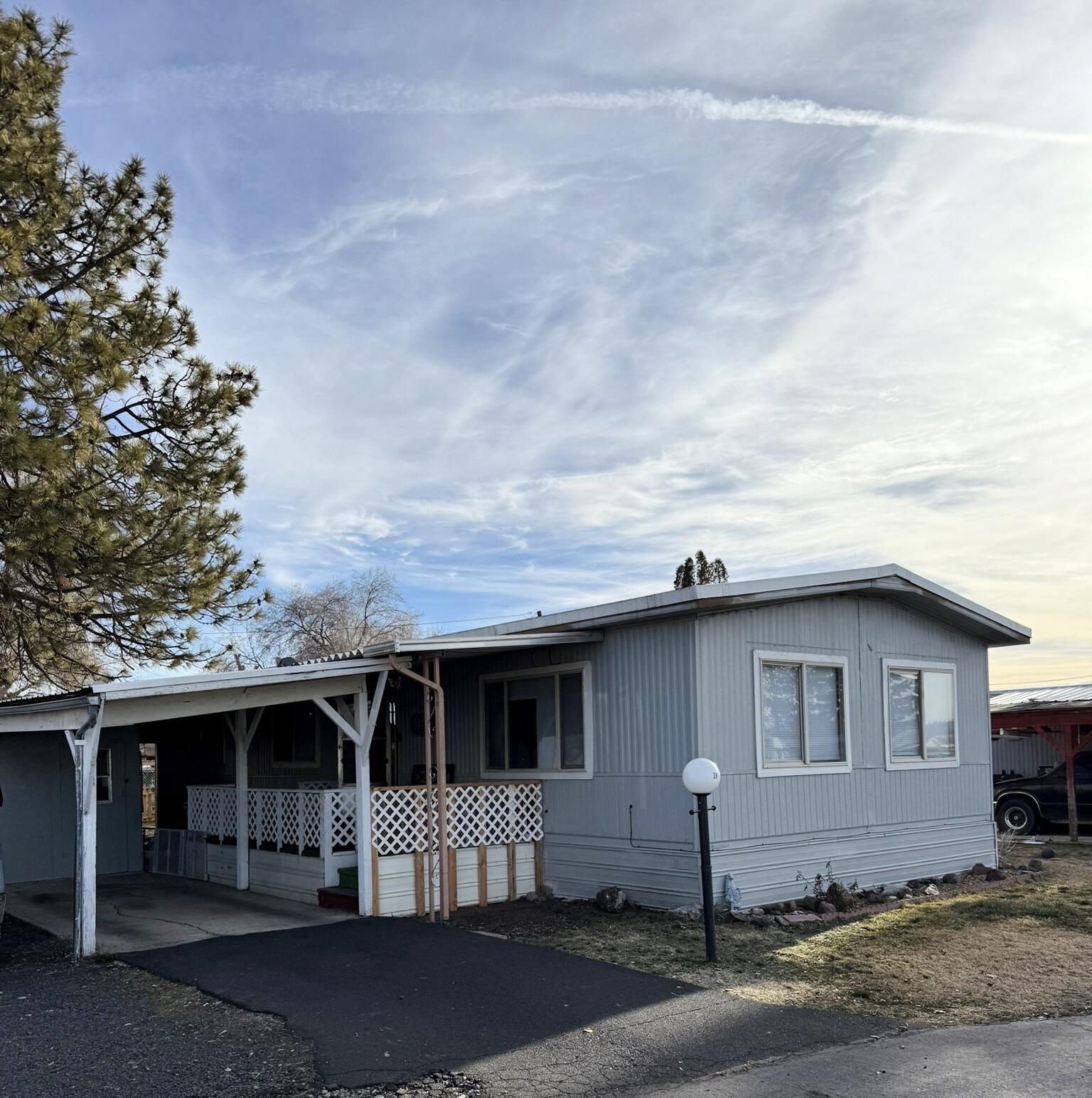 New carpet in nice two bedroom one bath manufactured home in established park. Large bedroom with walk-in closet. Walk in shower. Covered carport parking and porch. External storage area with fenced back yard. Buyers must be approved through the park.  Park offers RV parking for an additional fee. Space rent is $630.09. Includes water, sewer and trash. Park has a dog policy.