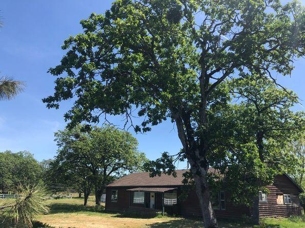 This cozy, rustic, 4 bdrm 2 bath ranch style home sits on over 58 beautiful EFU acres. Property is partially fenced with white fencing. This home has so many amenities! A huge 8 stall barn (34x60) with tack room, large shop is 28x36, two smaller shops are 12x20. Lovely salt water pool with rock waterfall and newer sand filter.  Interior of home is cabin-like with updated kitchen and bathrooms. Kitchen has beautiful knotty pine cupboards and stainless steel appliances. Living room has a high wood ceiling with beams and wood burning stove on a stone hearth. Some of the rooms have log walls which add an even cozier warm feeling to each room. Will not last long at this incredible price!! No irrigation rights.