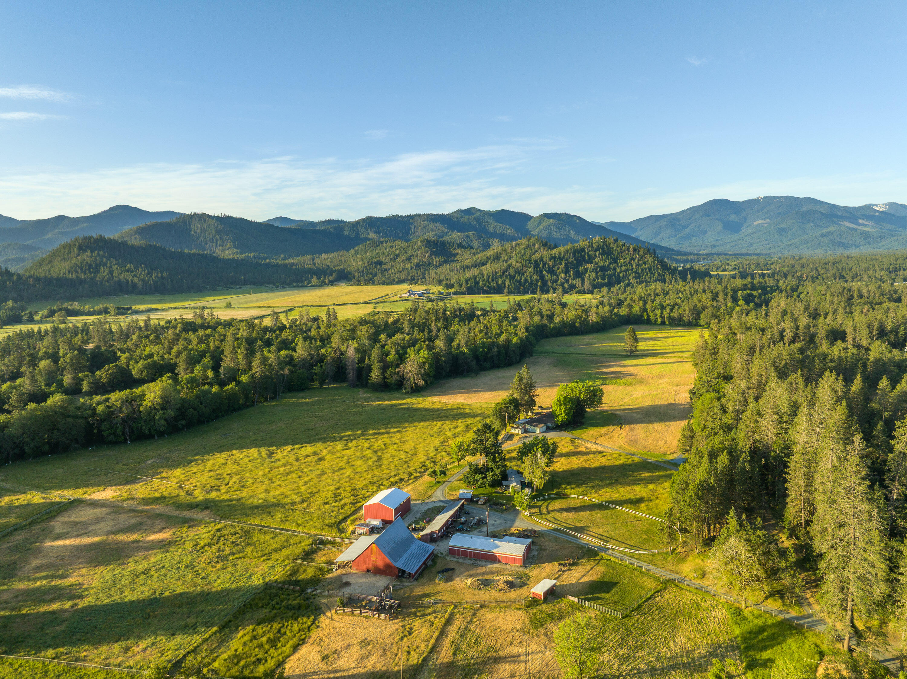 Located in Southern Oregon's Applegate Valley, this 112.7-acre ranch offers a rare blend of beauty, function, and privacy. The land includes 42 acres of irrigation rights from Williams Creek, with gently rolling pastures, mature trees, and three ponds. The main home is a spacious 3,771 sq ft ranch-style residence with attached guest quarters, while a second 2-bedroom home provides flexible living or rental use. Over 13,000 sq ft of barns and outbuildings support livestock and ag operations, including a horse barn, historic hay barn, and multiple sheds. The setting offers exceptional recreational opportunities, including hunting, riding, and exploring your own private valley. Zoned EFU and ideally suited for grazing, hay, or vineyards, this is a working ranch with incredible potential. Just minutes from Grants Pass and the heart of Southern Oregon's wine country, this property offers rural lifestyle and a sought after location!