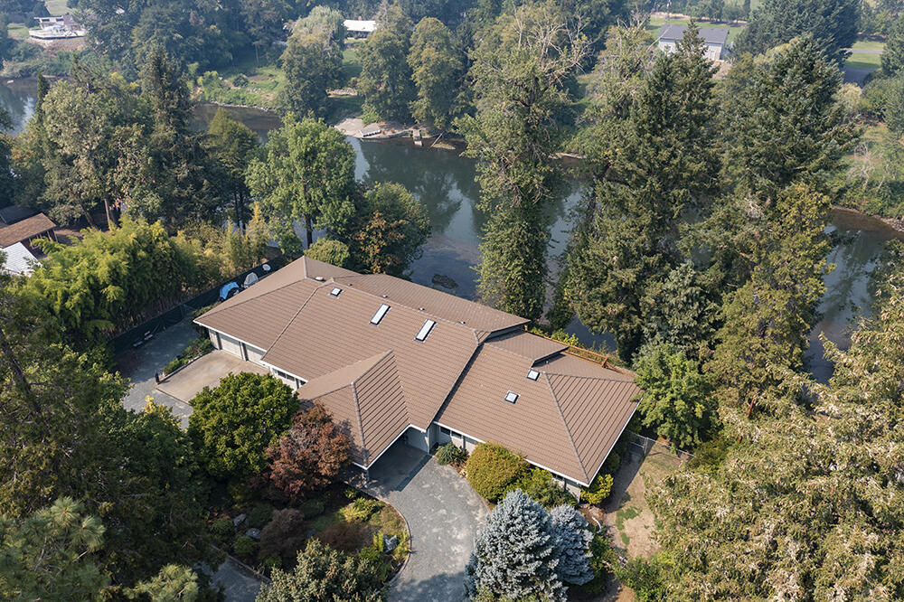 Outstanding Riverfront property on the Eisman Stillwater. This beautiful home was built in 1992 and features 3 bedrooms, 2.5 baths, and approx. 3304 sf., office, great room with extensive windows for incredible river views and an abundance of natural light, vaulted ceilings, formal dining room overlooking the river, dream kitchen with slate floors, two refrigerators (1 Sub Zero), a cook top, double ovens, warming drawer, slab granite counters and crisp white cabinets, skylights, primary room has views of river and a luxurious bath with soaking tub and cultured marble shower, walk in closet, guest room share a Jack and Jill bath set up. Enjoy the river even more with 2 decks one is covered and can easily be screened. On the outside there's an approx. 2000 sf shop with finished room with a bath. Large water feature has waterfall, irrigated pasture, multiple full RV hook ups, fruit trees, security gate, Porte cochere entry, circle drive, steps to the river, and the list just keeps going.