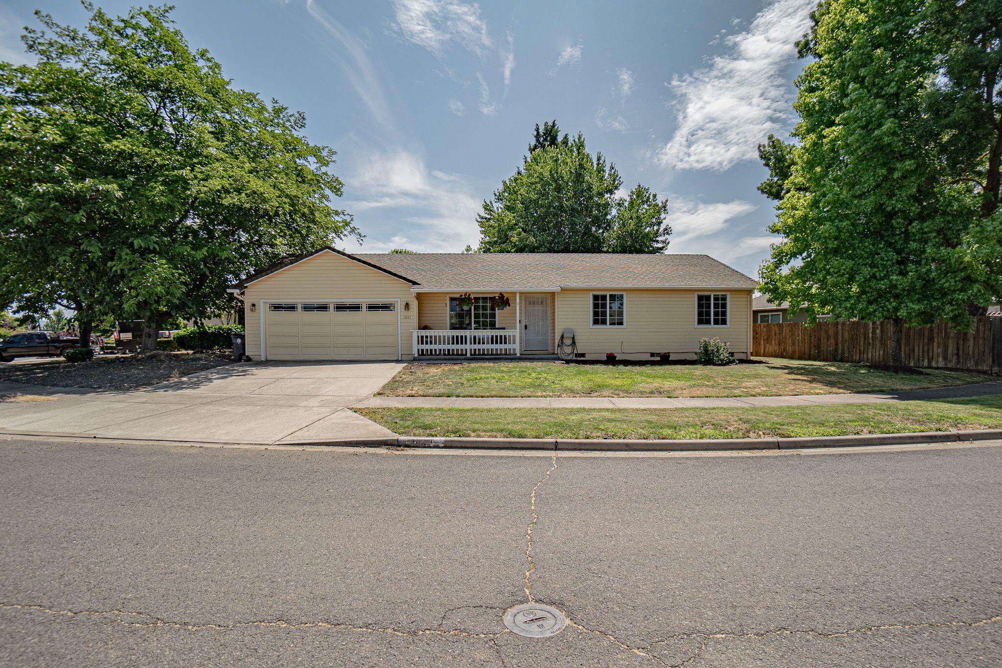 Bright and cheerful is this really great SW Medford home with a fun and railed country porch! There are so many great features, open spacious kitchen and vaulted ceilings, sky lights, solar tubes-built ins! The dining has a bay window, and in the living room lots of natural light pouring in. Open concept brings everyone together in the space with warmth. The 3 bedrooms and guest bath are good sized; the master has ensuite bathroom. Laundry room is nice sized and leads to the double car garage. Nice smaller maintenance backyard and pretty front with mature trees. Lot size is shaped so that there is ample side yard space.