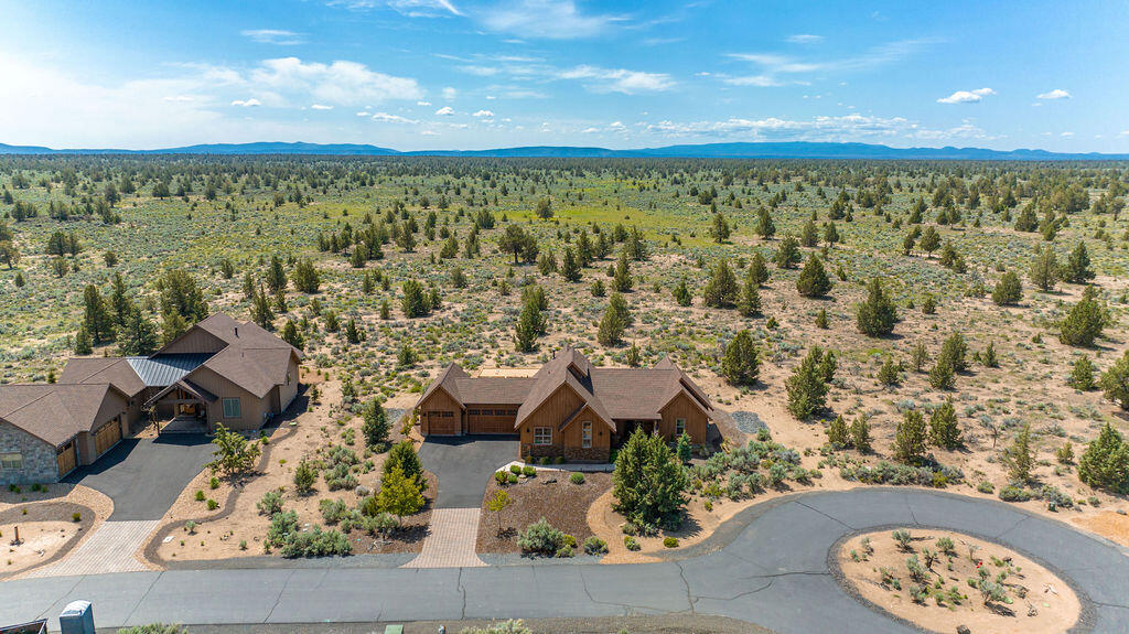 Melding beautifully with its stunning Brasada Ranch location, this single story home is the perfect backdrop for your next adventure or relaxing retreat. Being sold as a fully turnkey and operational vacation rental, the wonderfully curated furnishings and accessories are all included in the sale. Three bedrooms, three full bathrooms and a vaulted great room floor plan provide a spacious living experience. The large granite island, abundant cabinetry and stainless steel appliances make this kitchen a pleasure to cook in & a natural gathering spot. Plentiful windows overlook a private outdoor living area that includes a covered patio, built-in fire ring, hot tub and bocce ball court. From every spot on this property, you'll fall in love with the incredible night skies, the wonderful sense of privacy and the expansive view of resort common area and BLM land that backs this half acre lot. Brasada Ranch offers exceptional amenities including golf, restaurants, pool, spa, gym & much more!