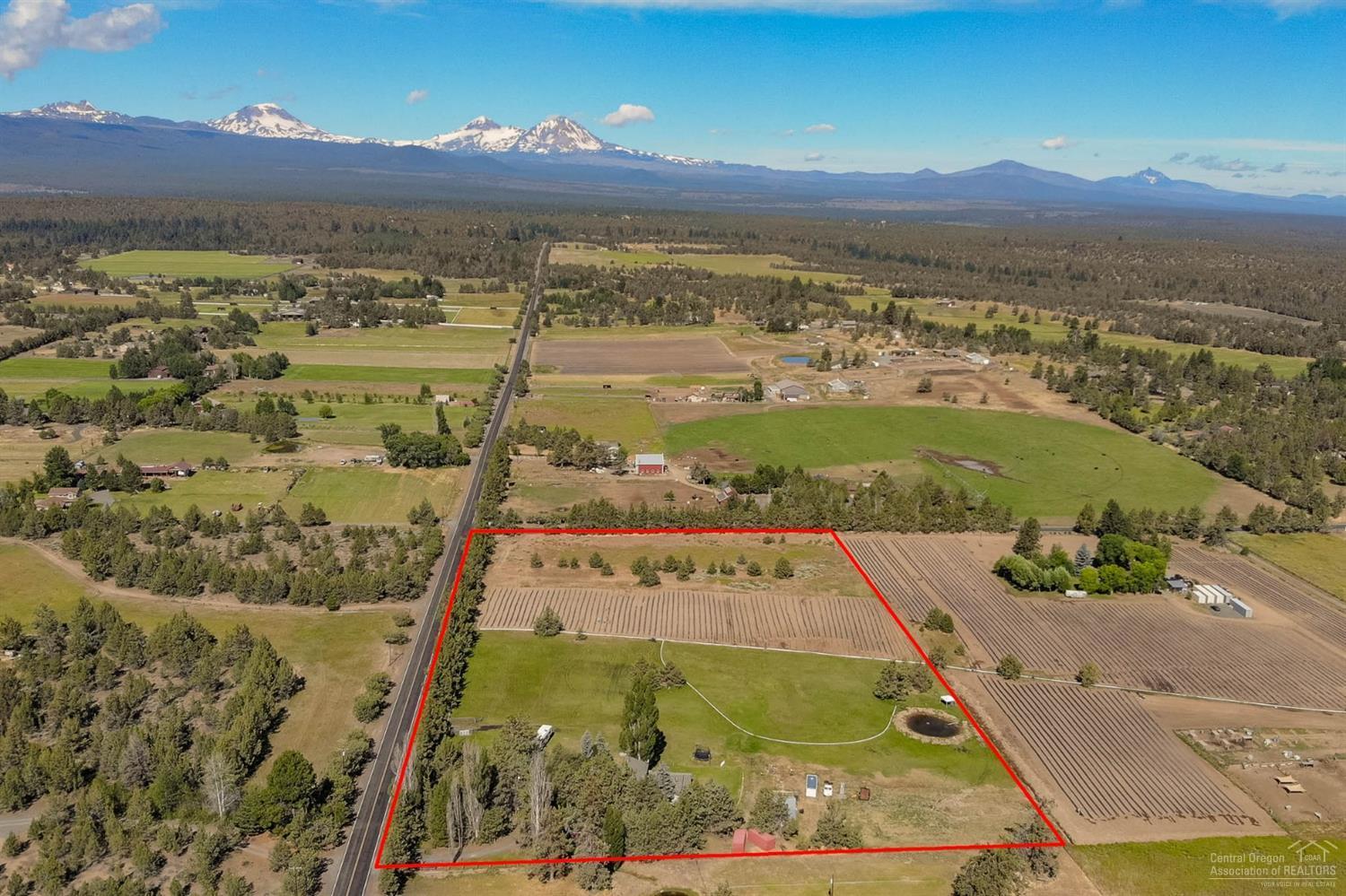 Desirable Tumalo area with grand mountain views on 9.4 acres. This home is 2541 square feet in size with 4 bedrooms and 3 bathrooms. Cozy living rooms and dining area with beamed ceilings, log accents and high ceilings an windows face the mountains and pasture. Master bedroom is on the main level with large walk-in closet and bay-window tub. This property is prime for rural living but minutes away from Bend.