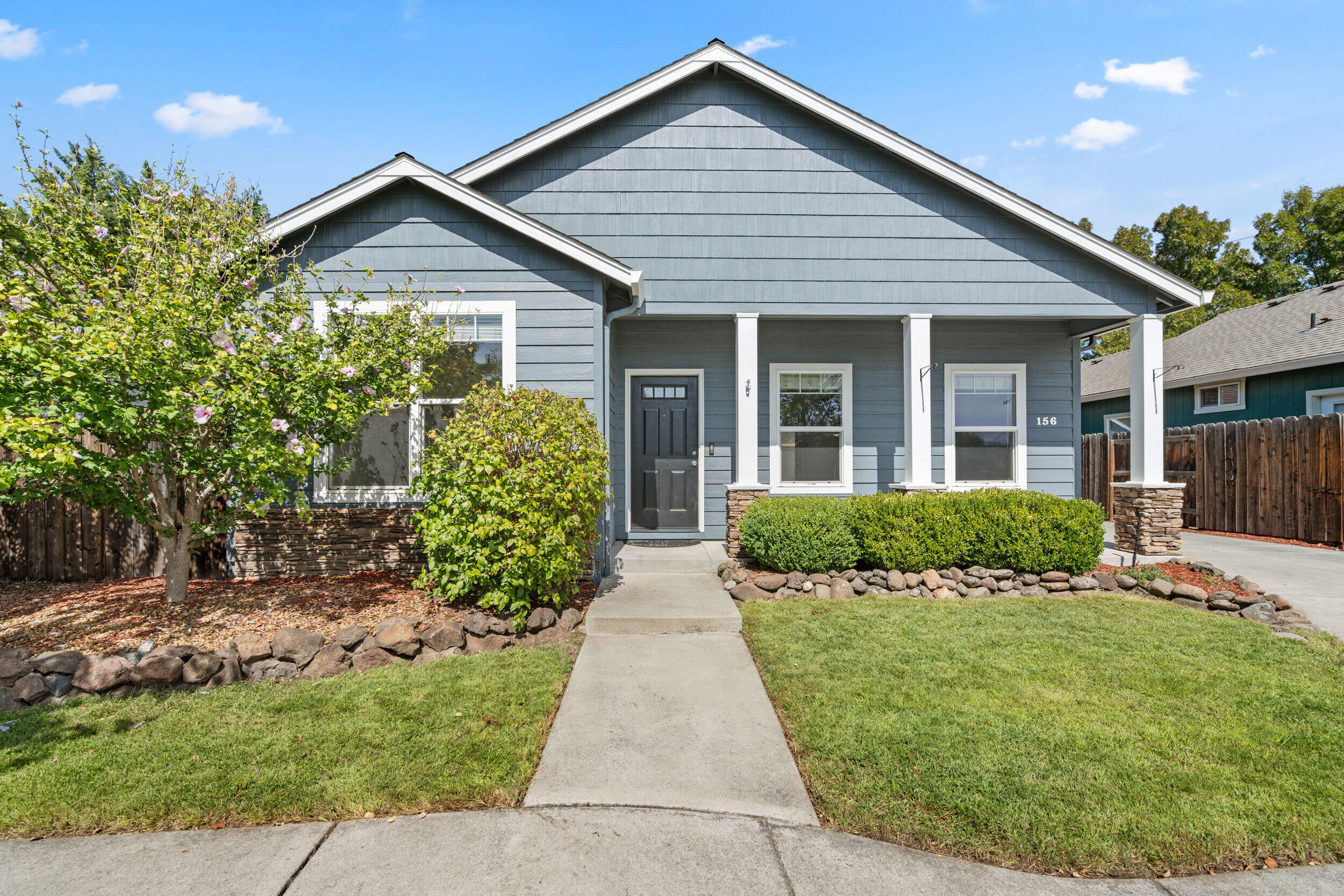 Single-level contemporary home in a lovely neighborhood with lots of parking and a fully fenced backyard. Built in 2004, this 3-bedroom, 2-bath home offers an open, easy-flow floor plan and tall ceilings. The kitchen is open to the light and bright dining room and includes all appliances: gas range/oven with microwave hood, brand new dishwasher, and refrigerator. The primary suite features a walk-in closet, and an ensuite bathroom with double sink vanity and shower with glass door. Enjoy abundant off street parking plus a finished 2-car detached garage. The fully fenced backyard is a private retreat with mature trees, lawn, covered patio. Conveniently located close to medical, shopping, and groceries.