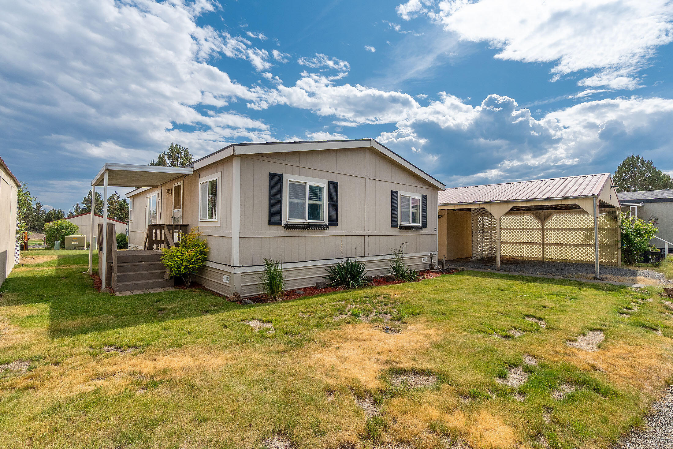 Lovely 3 bedroom, 2 bath mobile home located in a 55 plus community (Mtn View Mob Park) Turn key ready! A great floor plan with a large light & bright kitchen that flows into the vaulted living room which is nice and open. Lots of counter space allowing for a breakfast bar and plenty of room for a dining table. All appliances included! Enjoy the enlarged covered deck great for entertaining along with a covered front entry deck & storm door. The primary bedroom features a walk-in closet & adjoining bath. Nice separation of bedrooms & baths. Central-air heat pump provides A/C as well!  Space rent is $625 a month and includes double carport, storage shed, water, sewer, trash. Close to the Redmond airport with easy access from Hwy 97 to Bend and/or Redmond. Easy to show, set up a tour today!