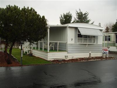 Senior Park. 55+ Home is furnished but seller is not living in the home. Well maintained, cute singlewide with lots of built-in drawers and storage cabinets. Very efficient window A/C in living room and a newer furnace. Space rent includes water, sewer and trash, currently $336.00. TID for lawn irrigation. Personal property will be removed prior to closing.