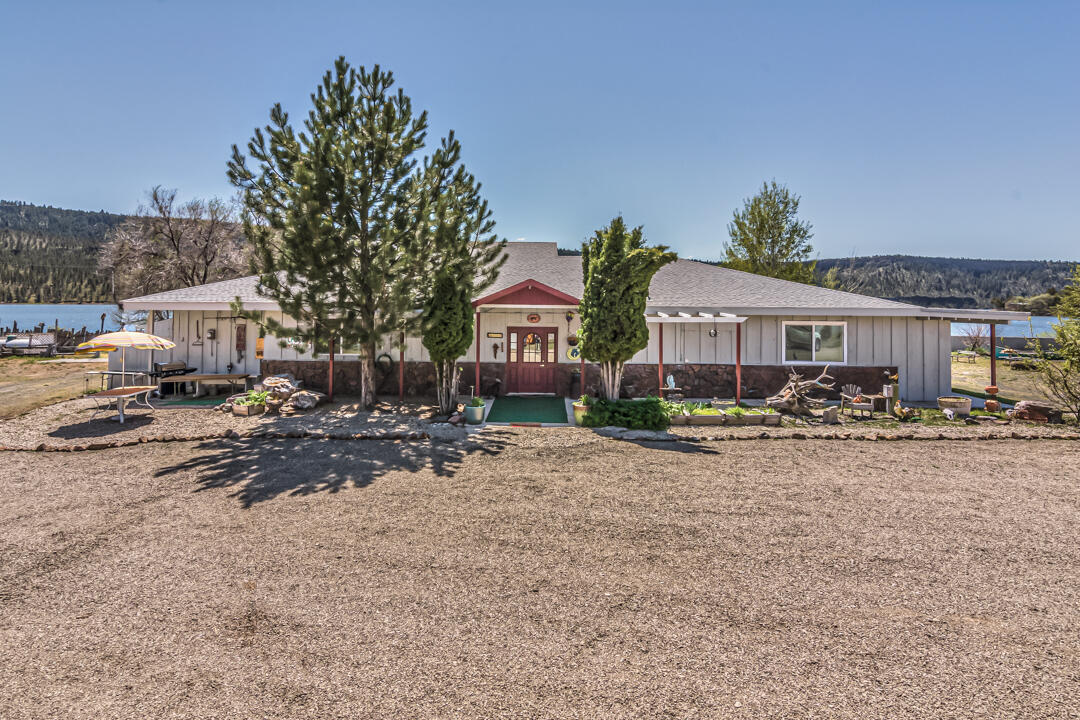 Imagine waking up in the morning, sitting out back of your home, drinking your coffee as you stare over the lake watching nature do what is does best....showing off! This unique history filled 4,279sf home with lakefront views on three sides, is situated on the banks of Ochoco Reservoir. This 1 acre property is flat with a shared private boat launch. This home would be great for a family, or if you wanted to live in part of it and rent one side or needed a place to put your mother-in-law, the possibilities are great. There are small wooded overnighter cabins plus a spot for an RV with full hookups. Prineville is just minutes away to the west, then heading east for a short drive, you are in the Ochoco Mountains giving you an abundance of recreational activities. This is one of those very rare properties that doesn't come on the market very often. If you have always dreamed of looking over the water from your back window, here is your chance!